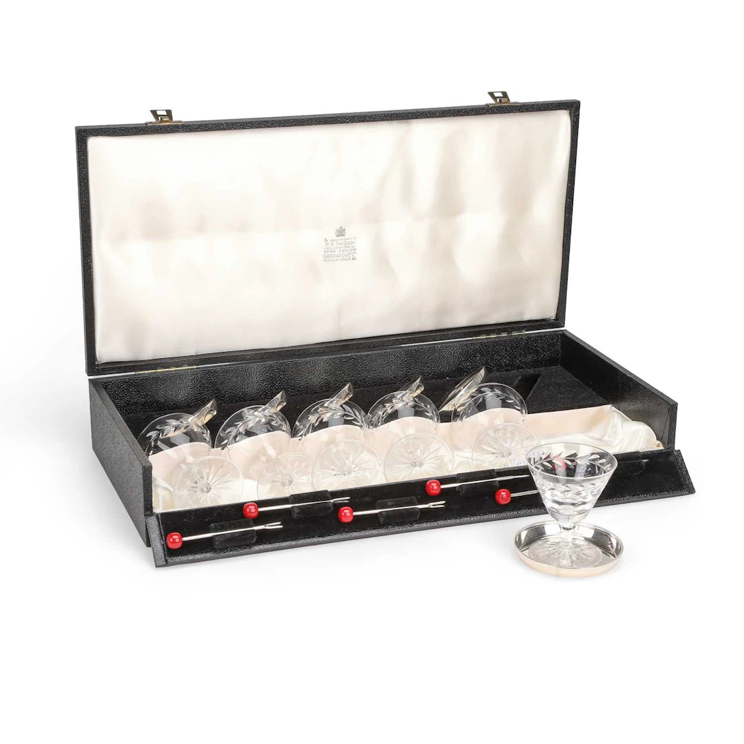 A CASED ELIZABETH II SILVER AND CUT-GLASS COCKTAIL SET