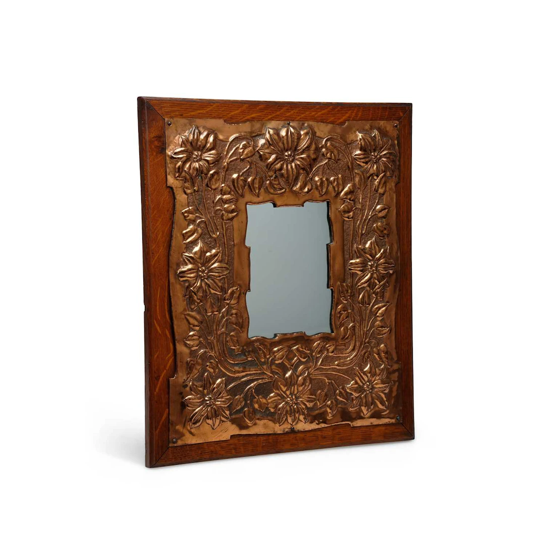 AN ARTS AND CRAFTS COPPER AND OAK WALL MIRROR
