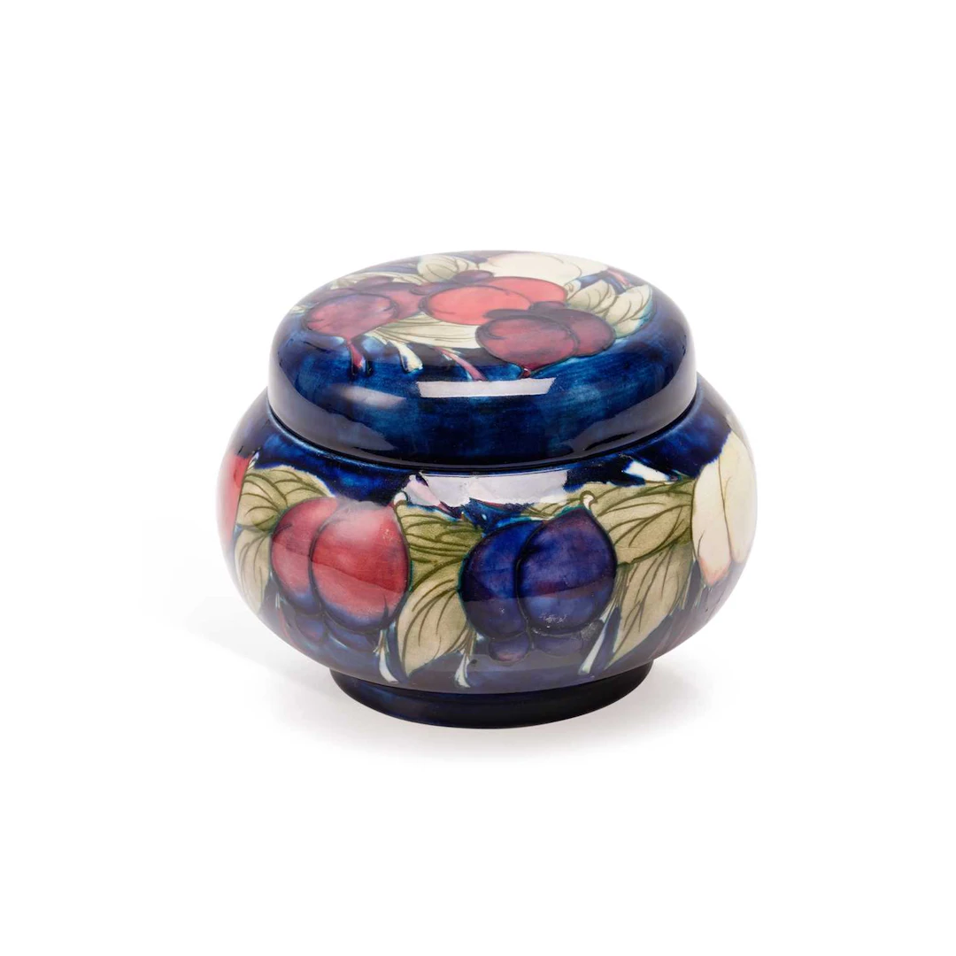 A MOORCROFT 'WISTERIA PLUM' JAR AND A VASE