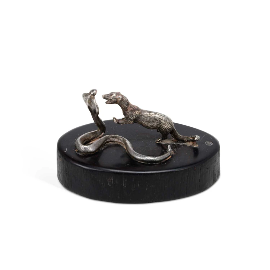 PATRICK MAVROS: A SILVER MINIATURE MODEL OF A MONGOOSE BATTLING A COBRA