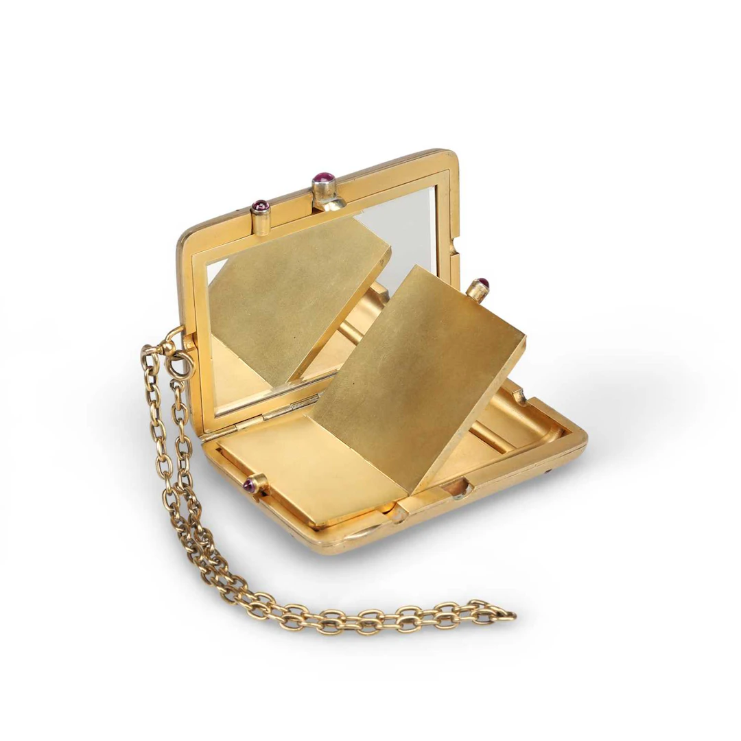 A CONTINENTAL SILVER-GILT AND RUBY-SET VANITY CASE
