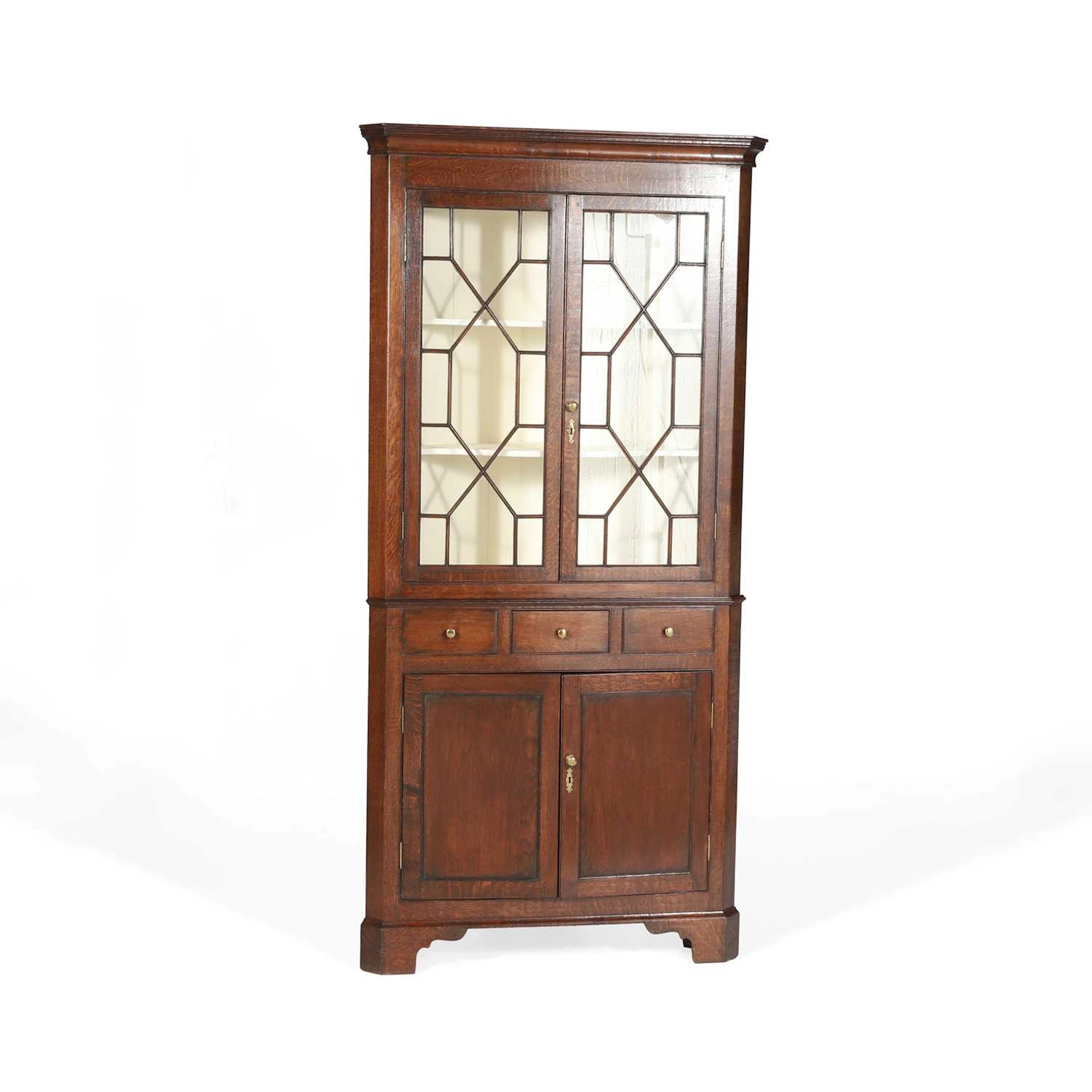 AN OAK CORNER CABINET