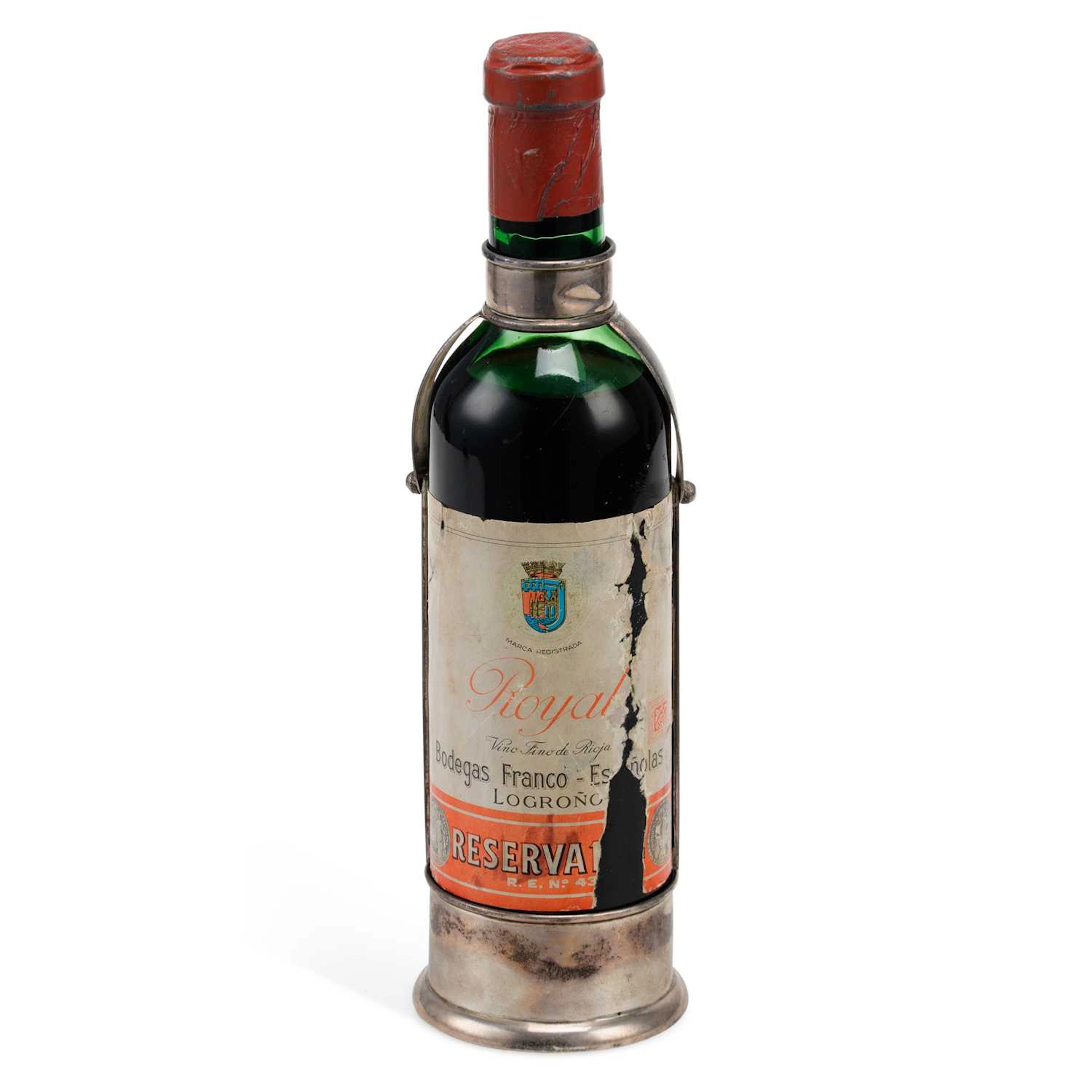 A SPANISH SILVER WINE BOTTLE HOLDER AND WINE BOTTLE