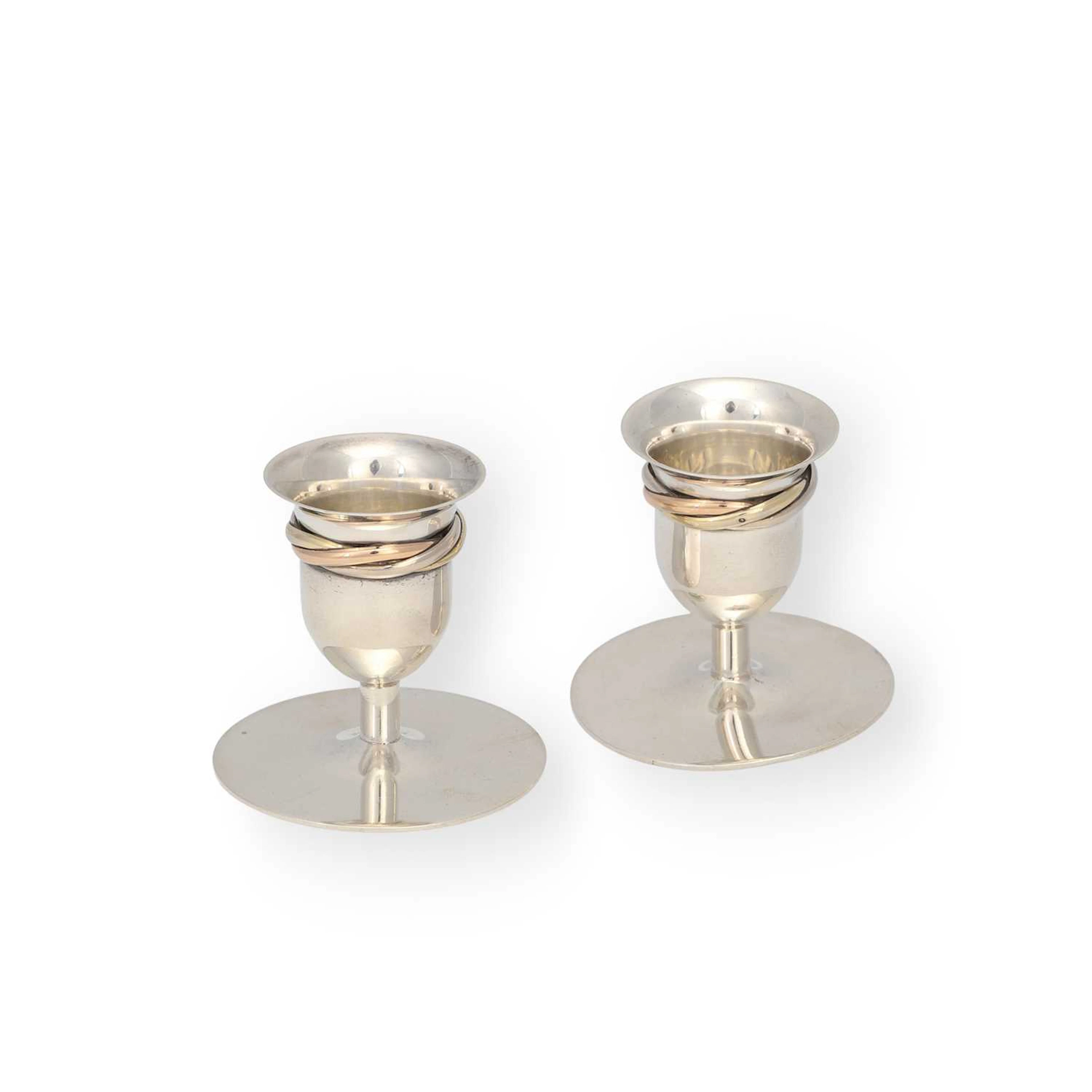 A PAIR OF CARTIER SILVER 'TRINITY' DWARF CANDLESTICKS