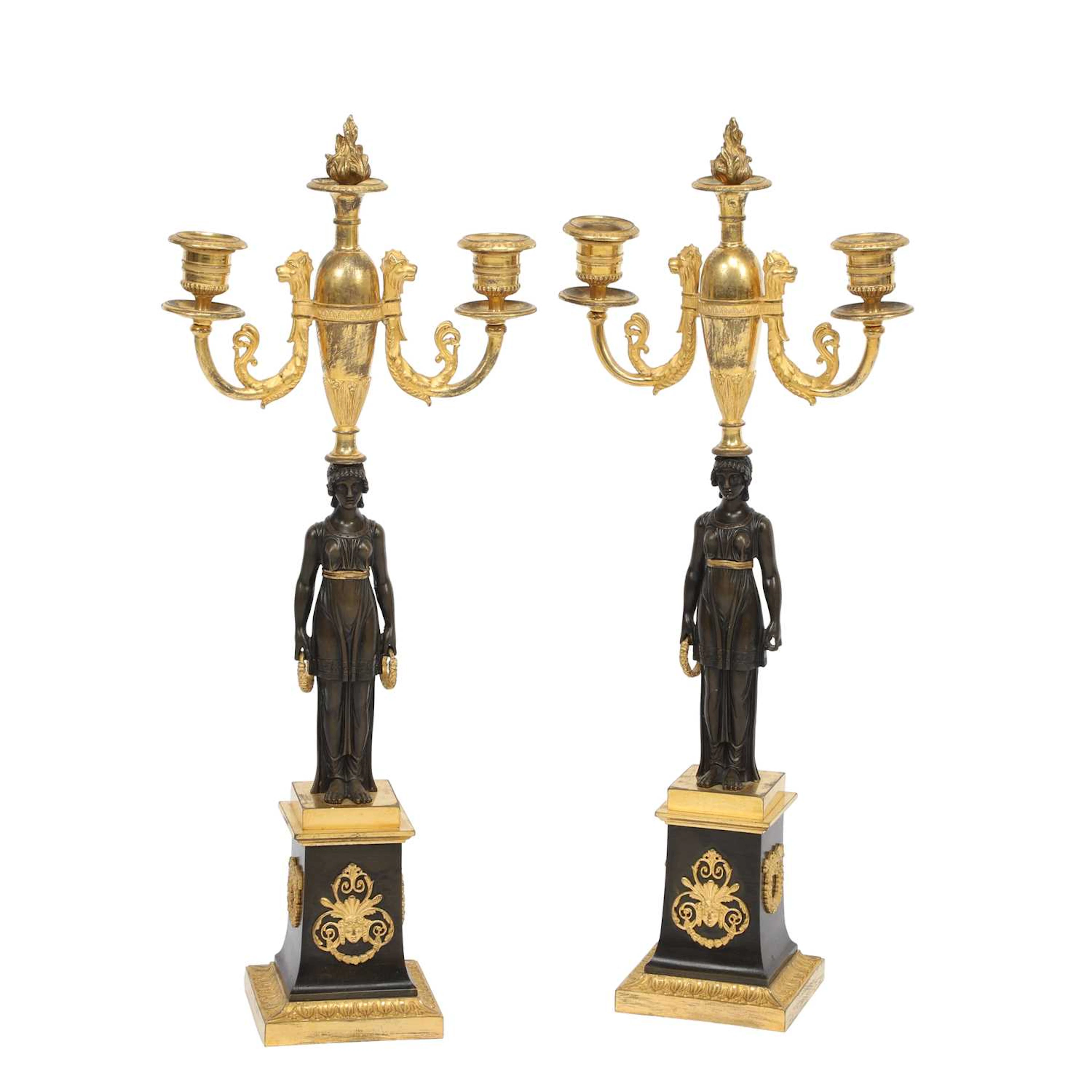 A PAIR OF FRENCH PATINATED AND GILT BRONZE TWO-LIGHT FIGURAL CANDELABRA