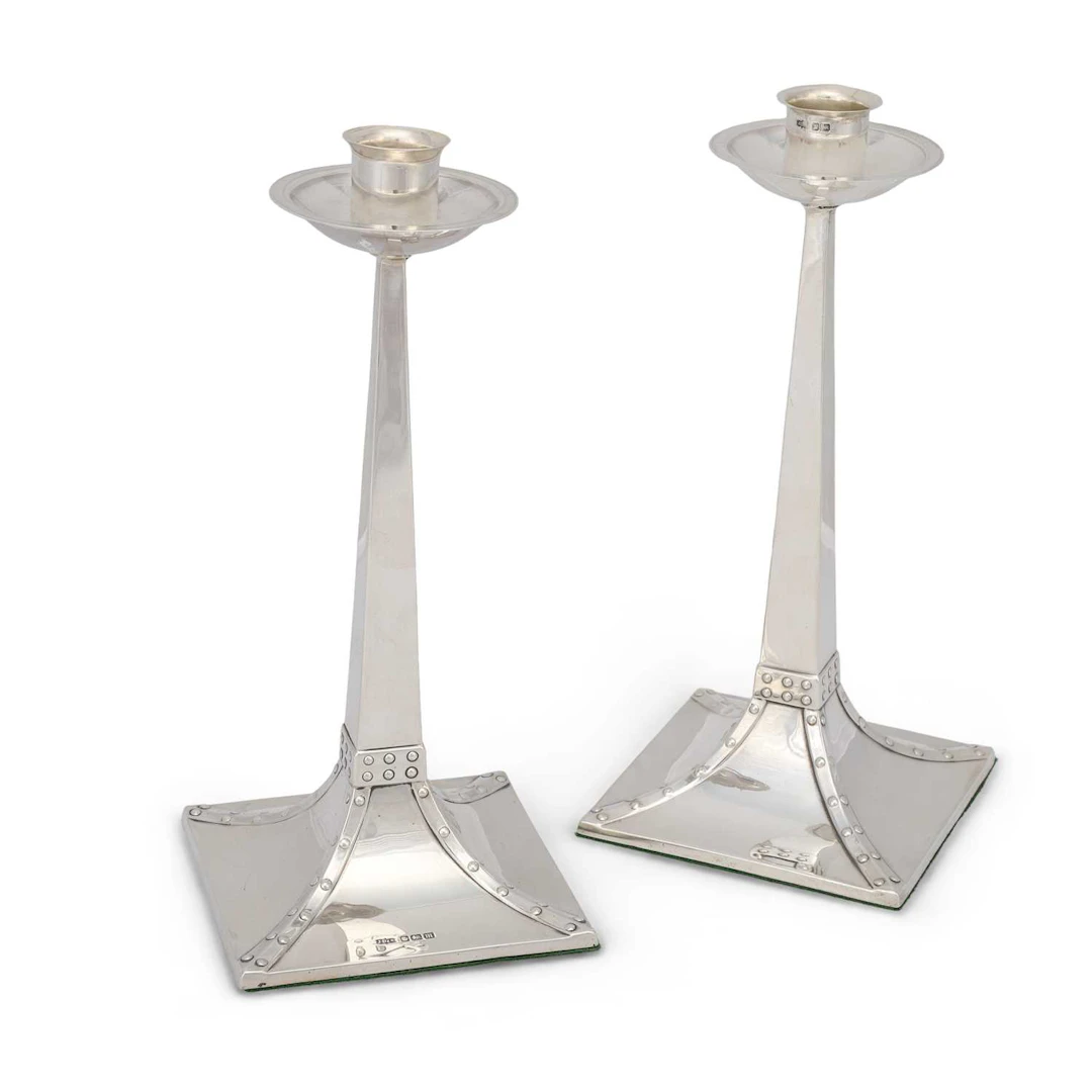A PAIR OF SILVER ARTS AND CRAFTS CANDLESTICKS