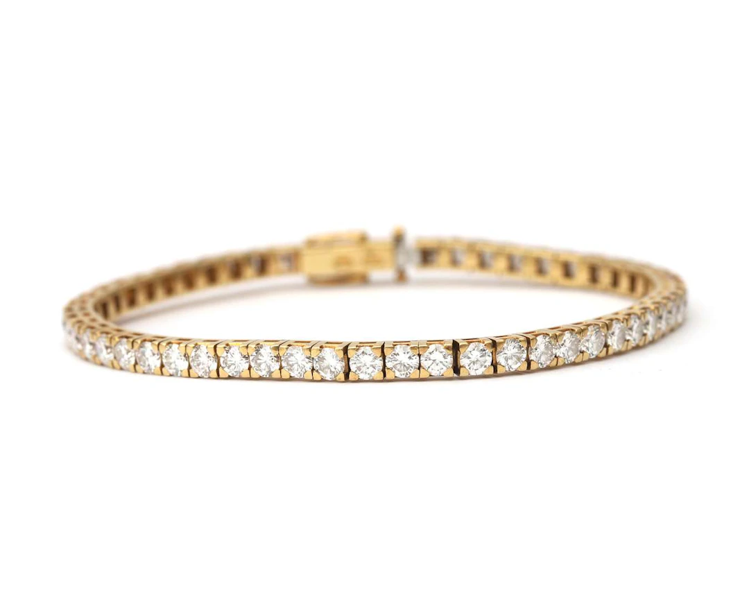 An 18k yellow gold tennis bracelet set with approx. 5.94 ct. of diamonds