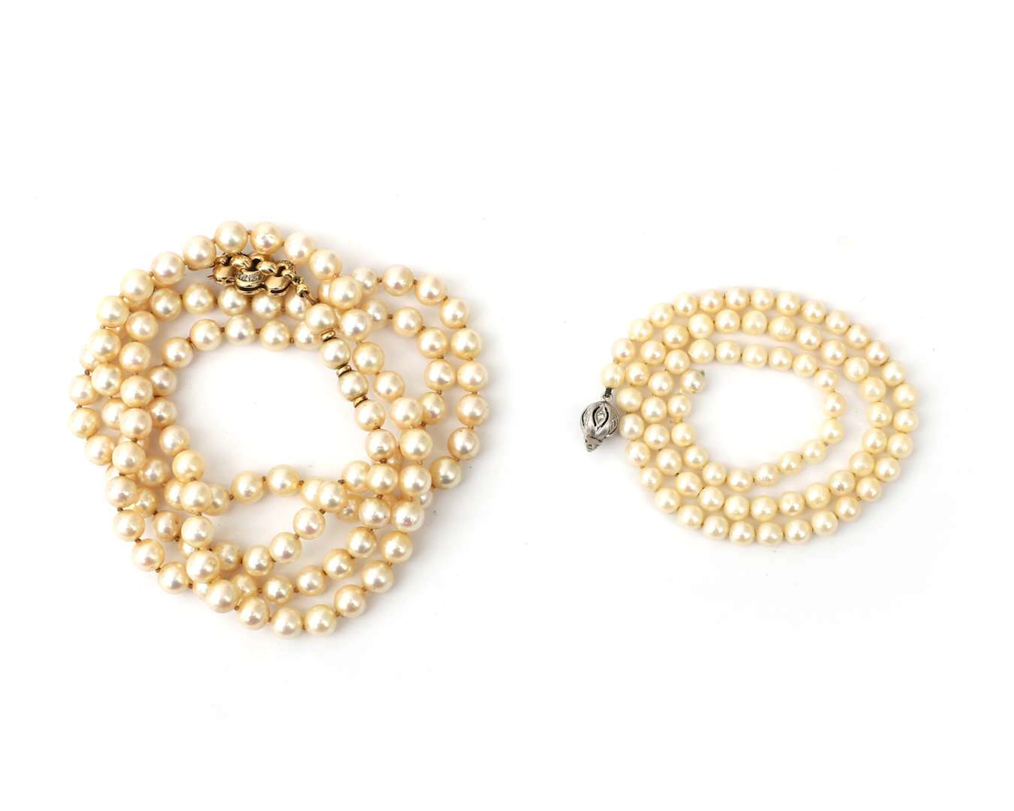 A lot comprising two pearl necklaces with 14k gold clasps