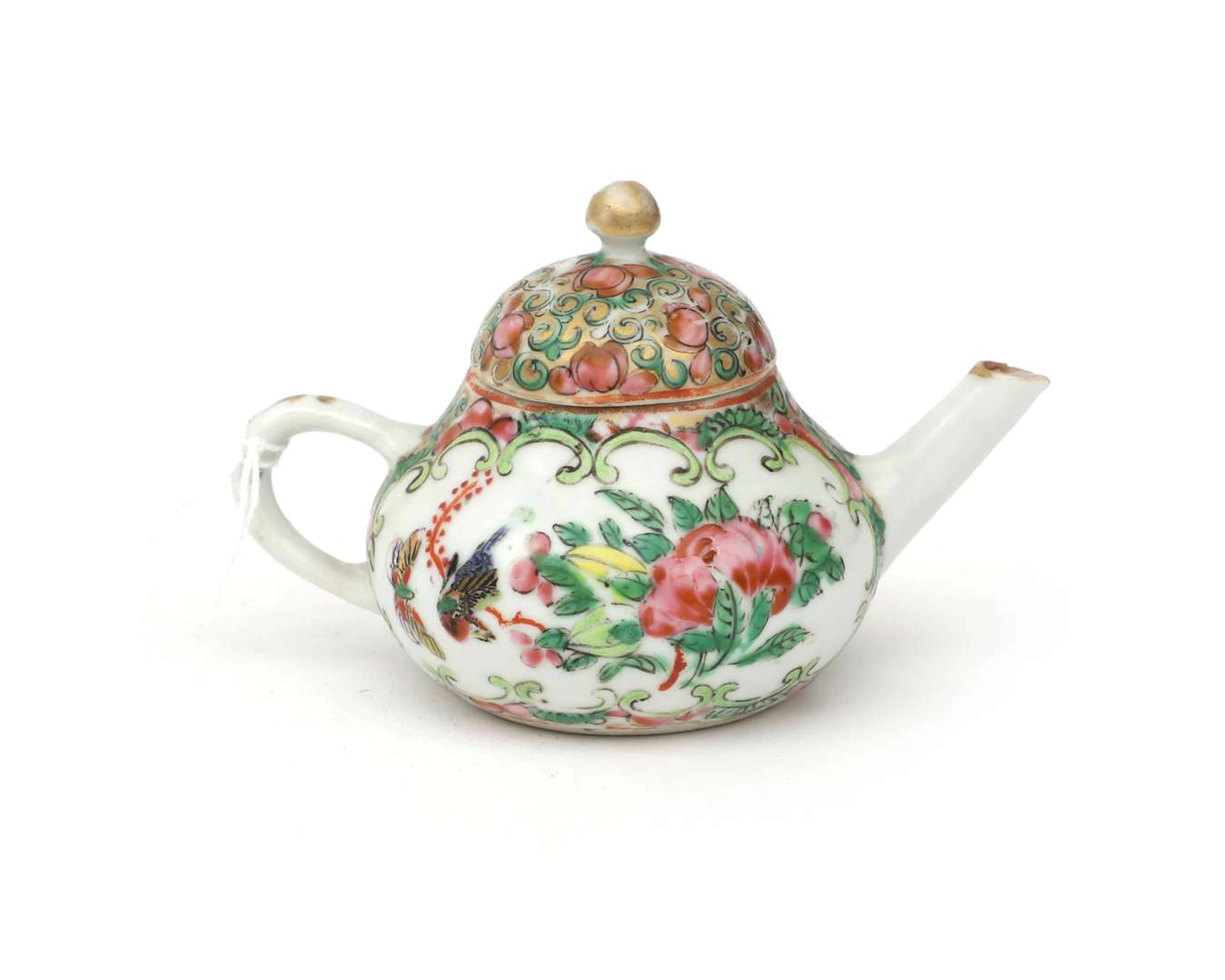A coloured porcelain miniature teapot. Famille rose floral decoration.