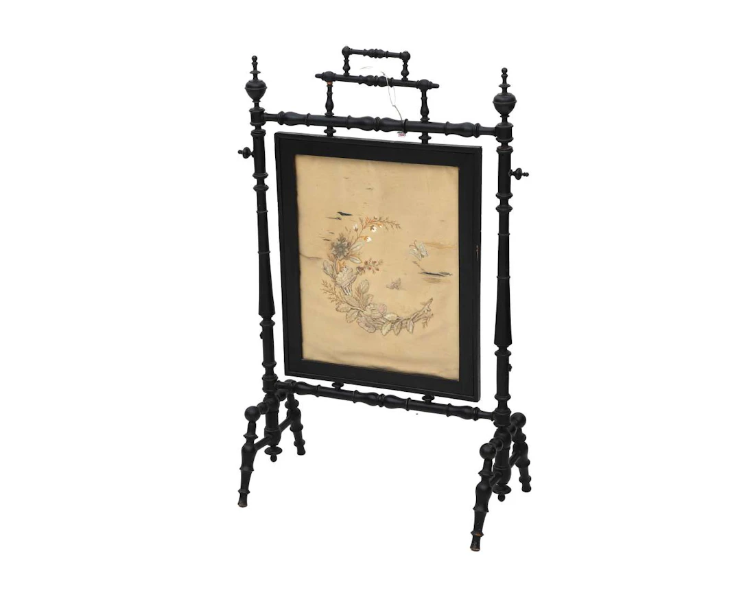 A blackened wooden folding screen with oriental embroidery. Circa 1900