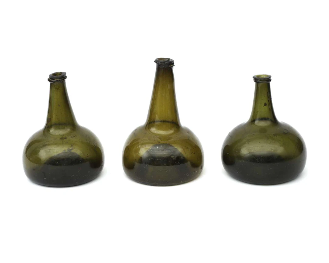 Three glass ‘cat’s heads’ (bottles), Holland, 18th century