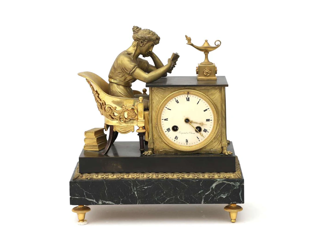 A bronze empire mantel clock 'La liseuse', after design by Jean-Andre
