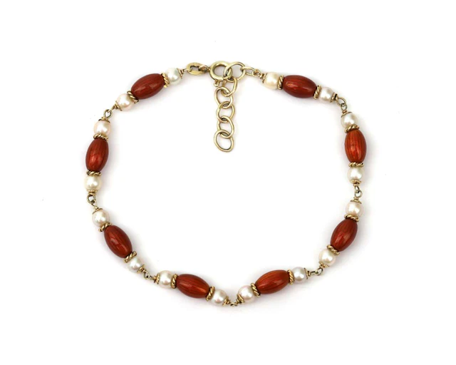 A 14k yellow gold bracelet with cultivé pearls and orange-red enamel