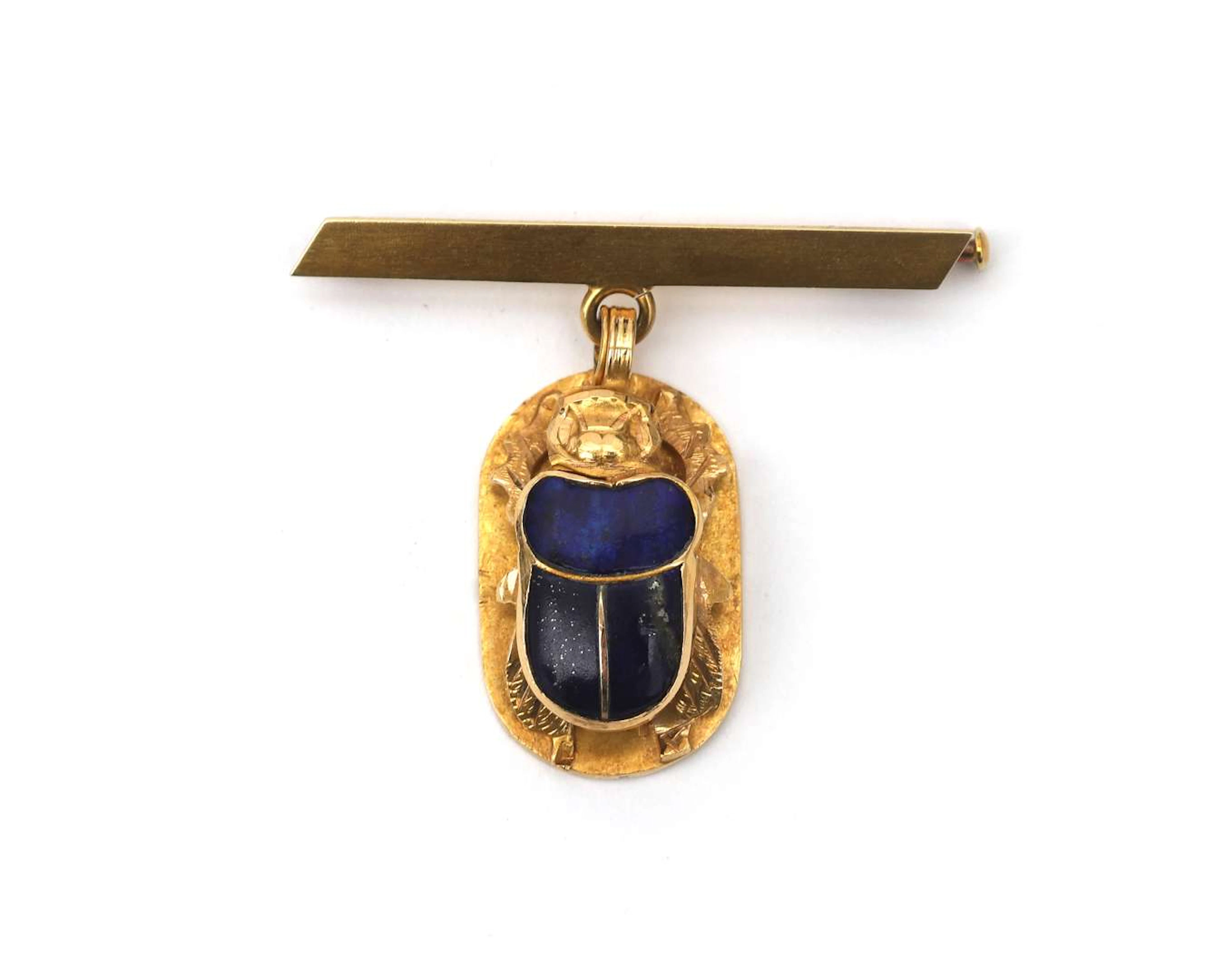 An 18k yellow gold bar brooch with a scarab pendant, set with lapis lazuli