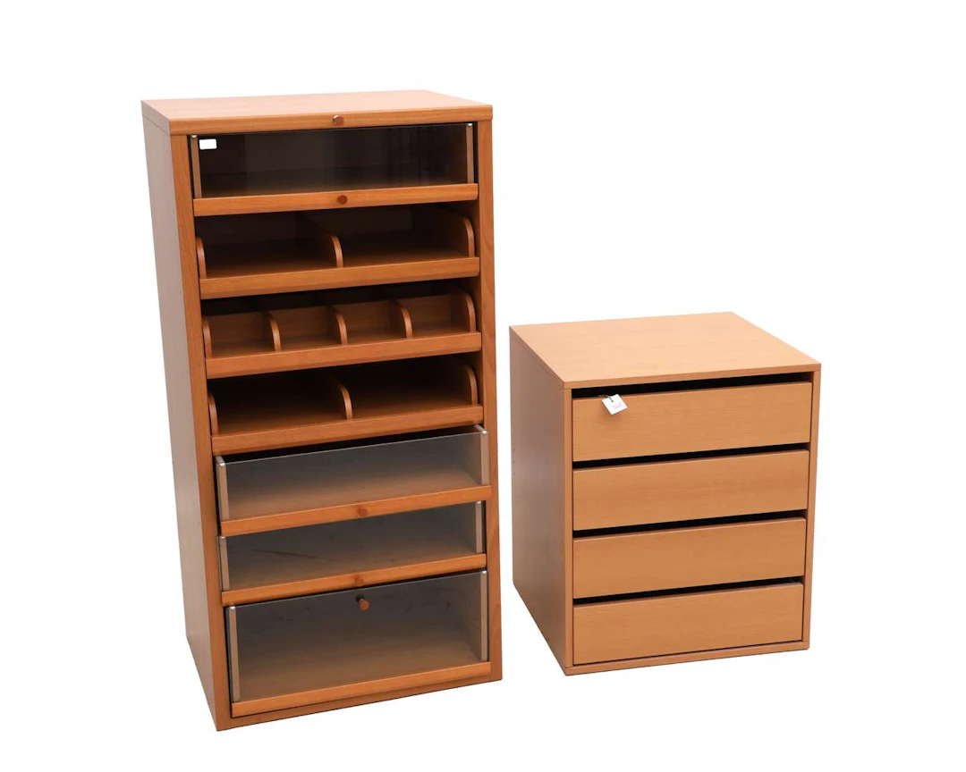 Two different wooden chests of drawers. One marked ‘Möller Design’