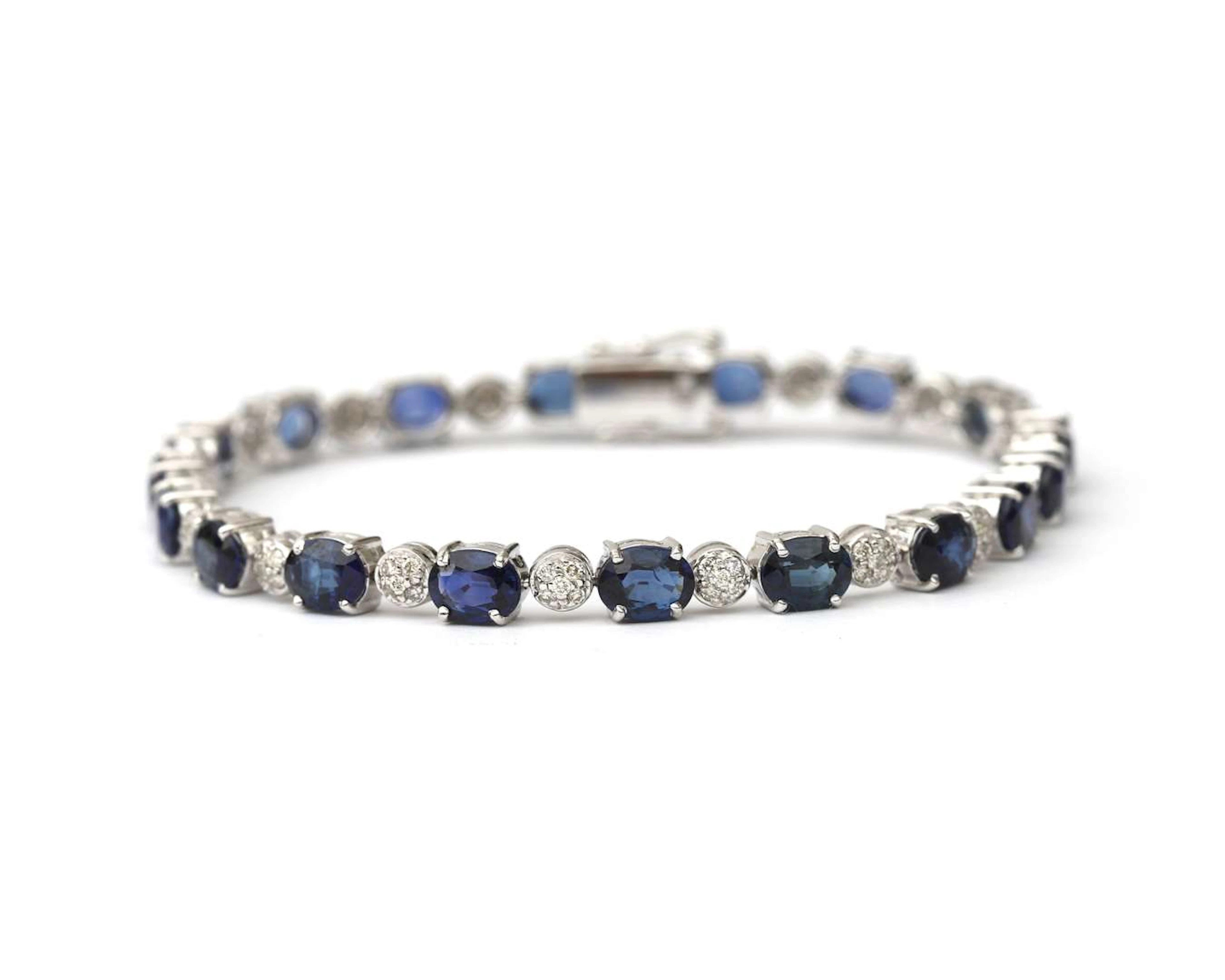 An 18k white gold tennis bracelet set with sapphires and diamonds