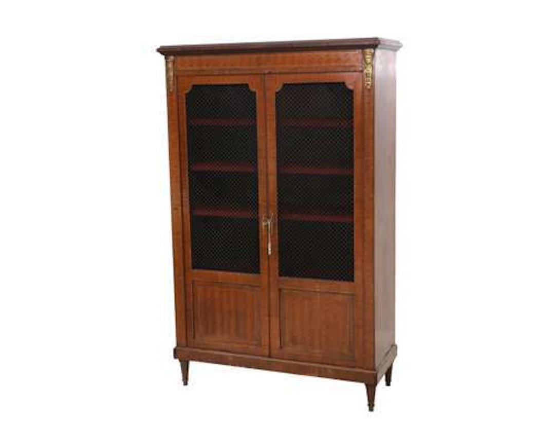 A two-door bookcase in inlaid walnut with a metal mesh panel in the