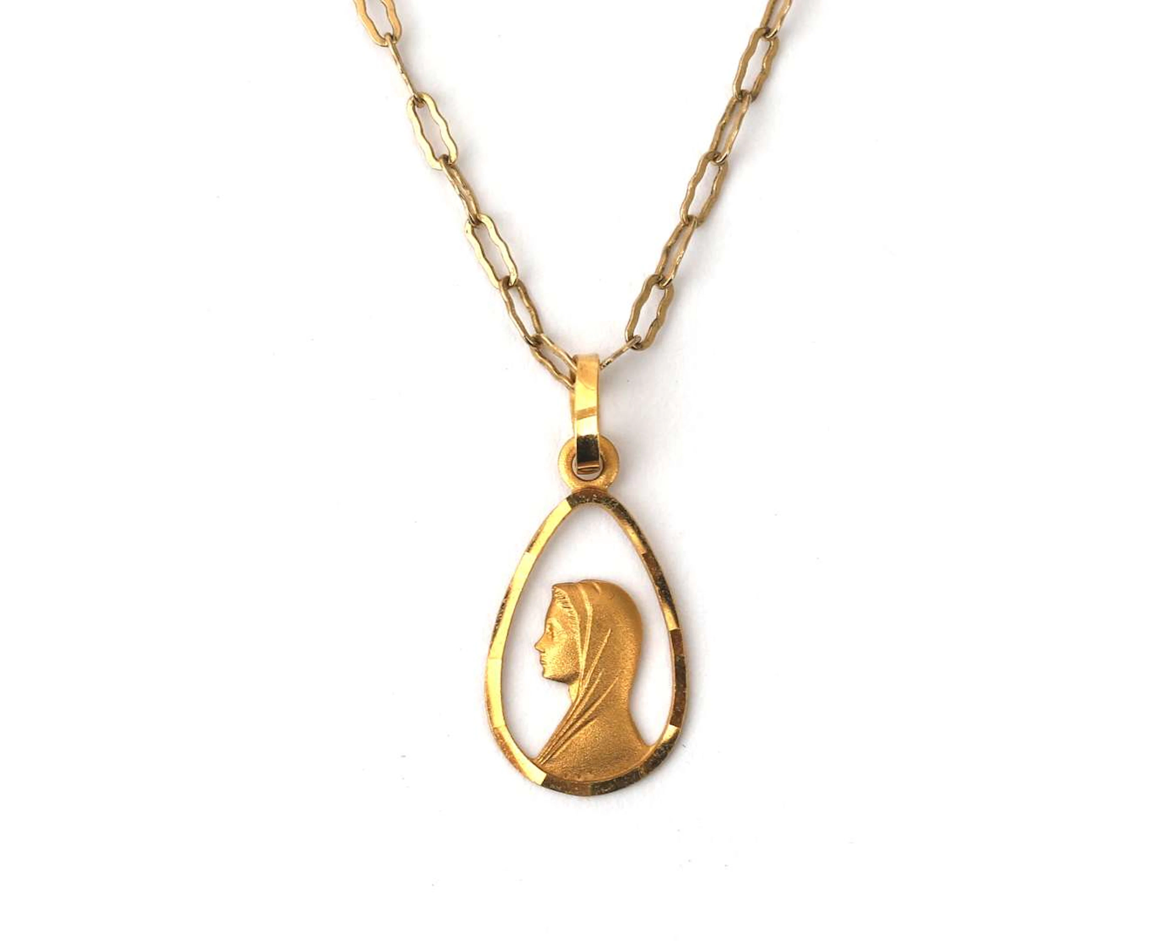 An 18-carat yellow gold religious pendant on a 14-carat yellow gold necklace