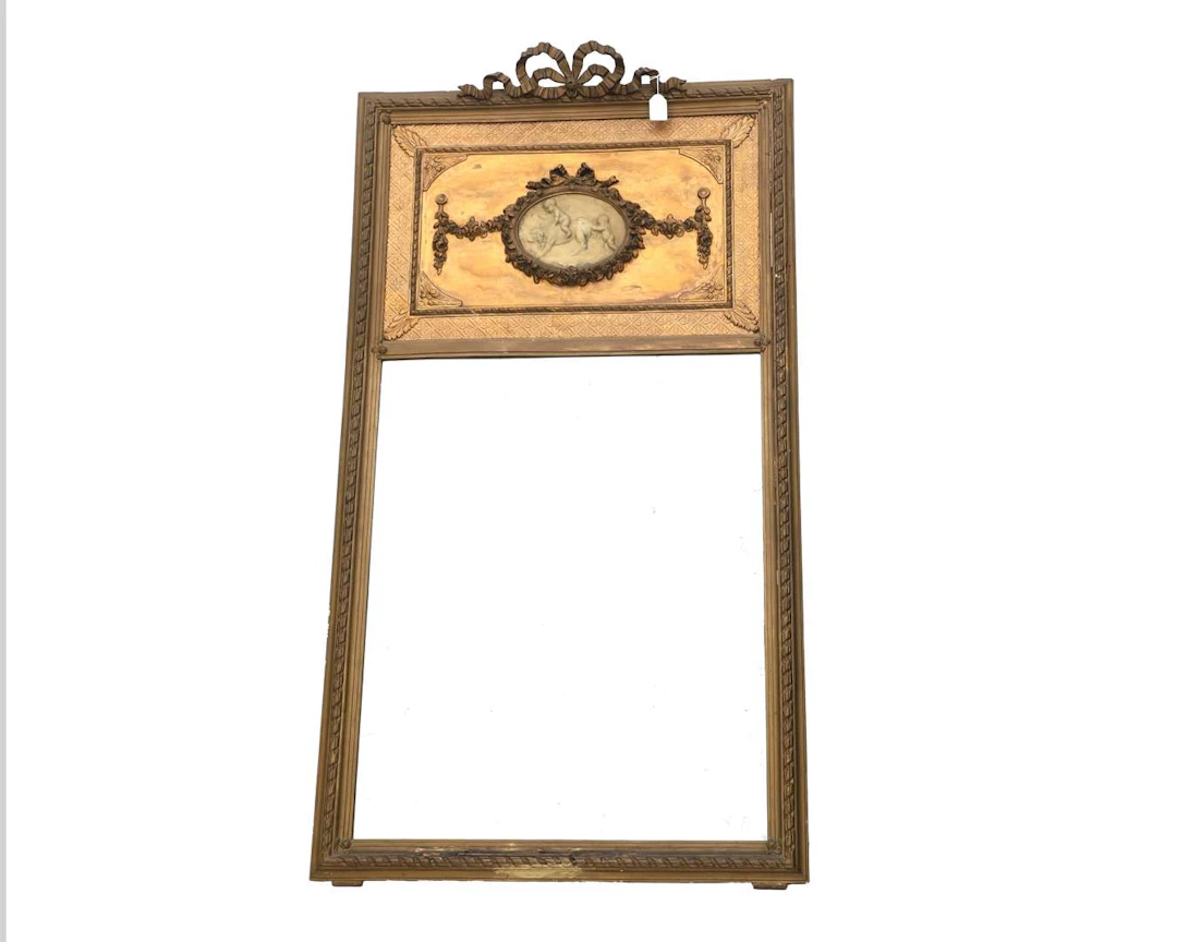 A cut glass mirror in a wooden frame with a plaster moulding. 20th century