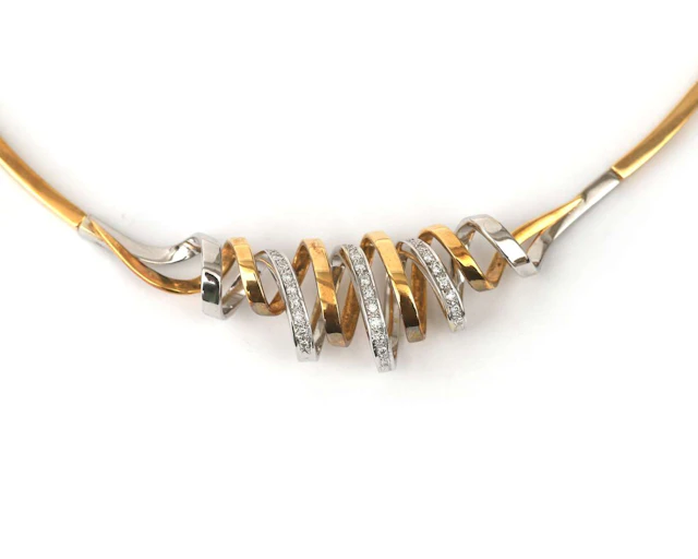An 18-carat two-tone gold choker necklace and brooch set with a diamond