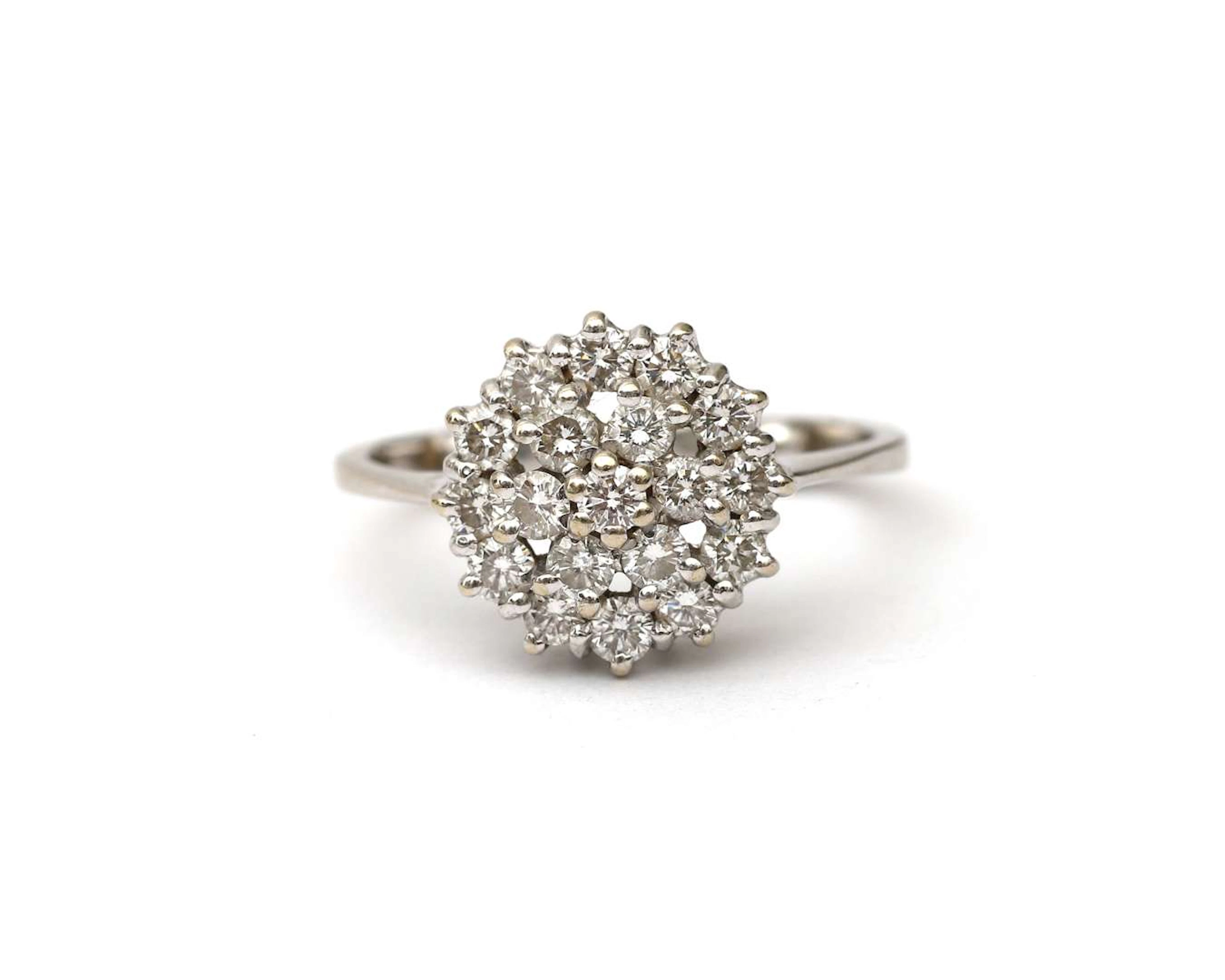 A 14k white gold rosette ring with a diamond
