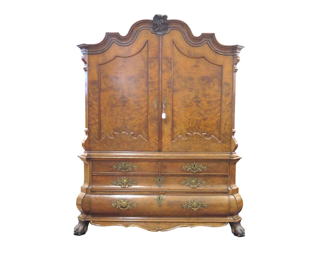 A walnut cabinet with a carved crest. 18th/19th century