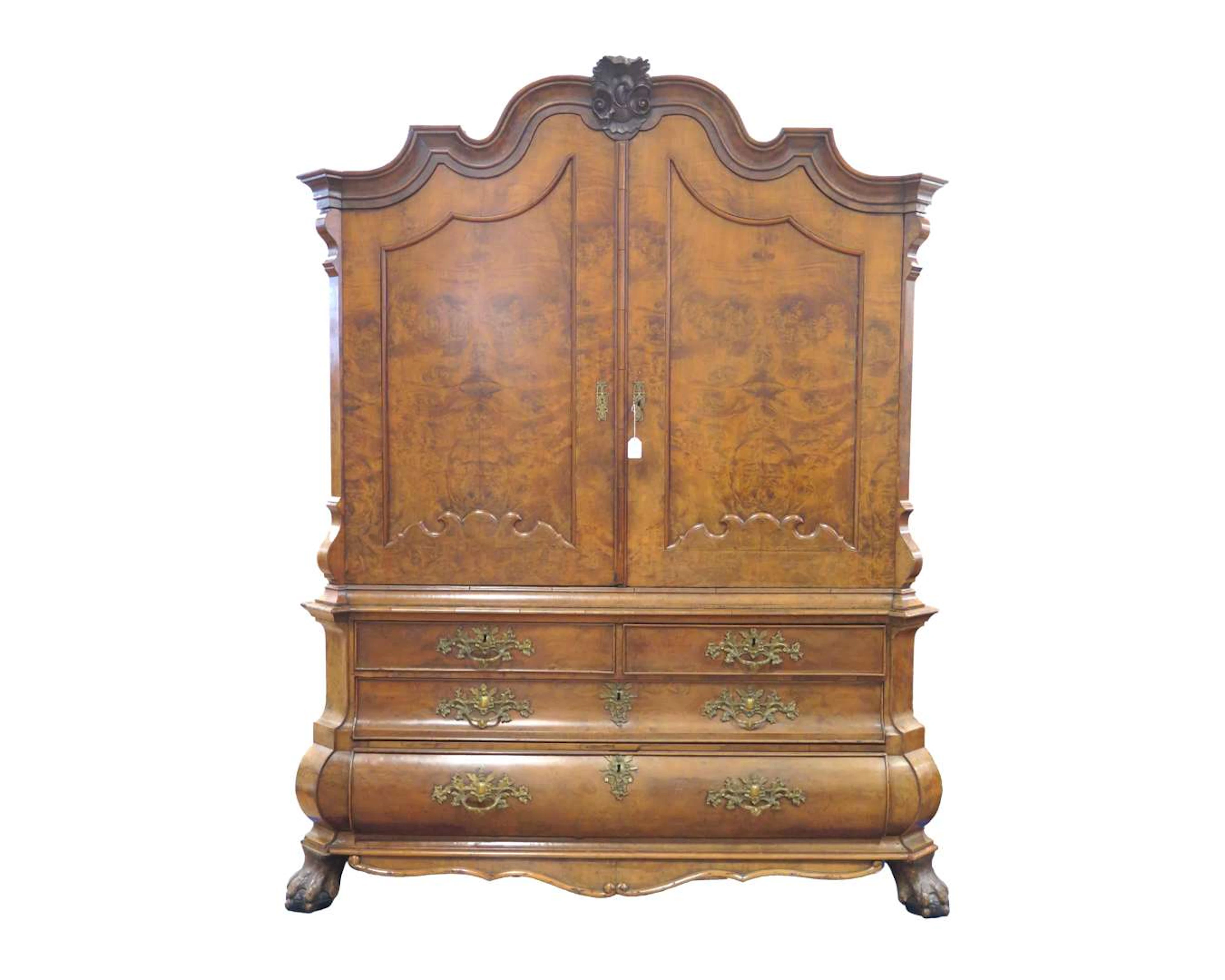 A walnut cabinet with a carved crest. 18th/19th century
