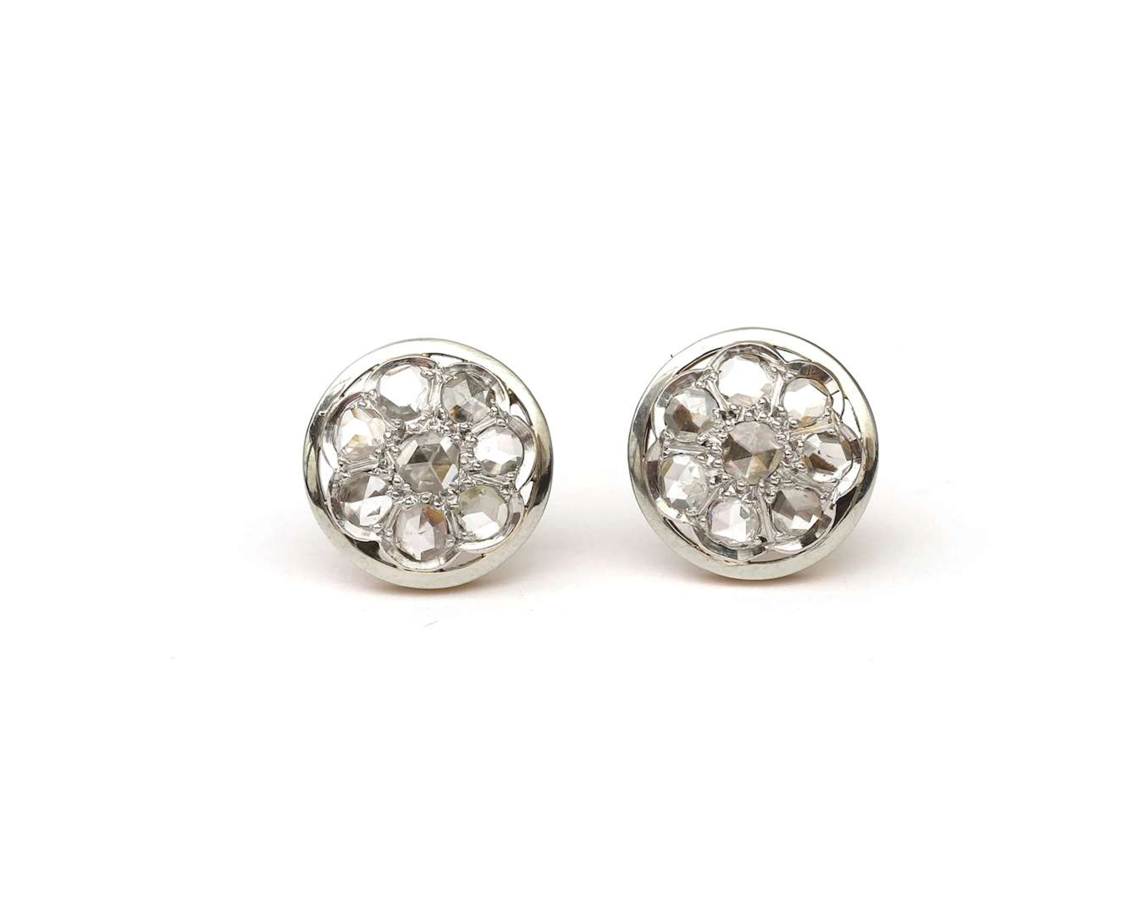A pair of 14k bicolour gold stud earrings with a rose-cut diamond