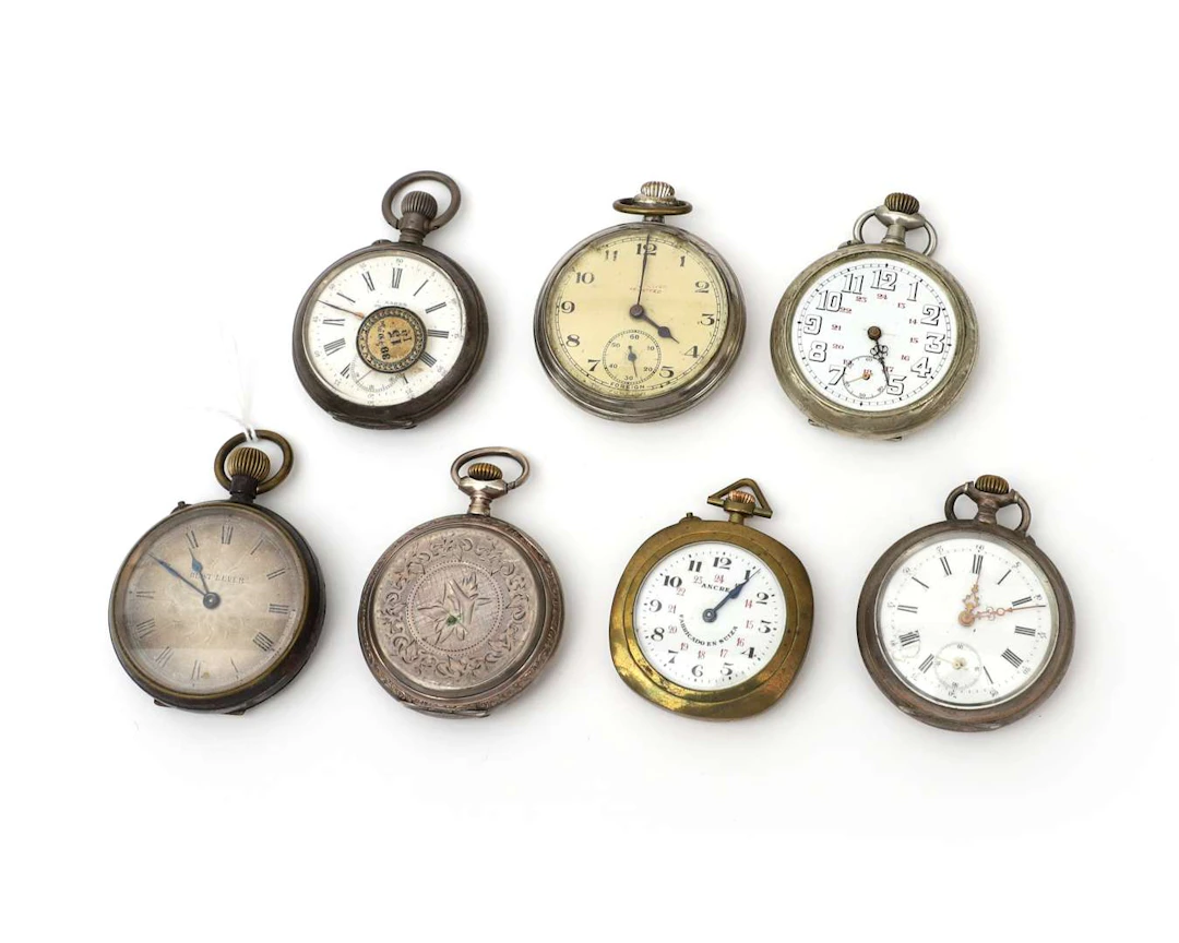 Seven pocket watches, including one with a silver case
