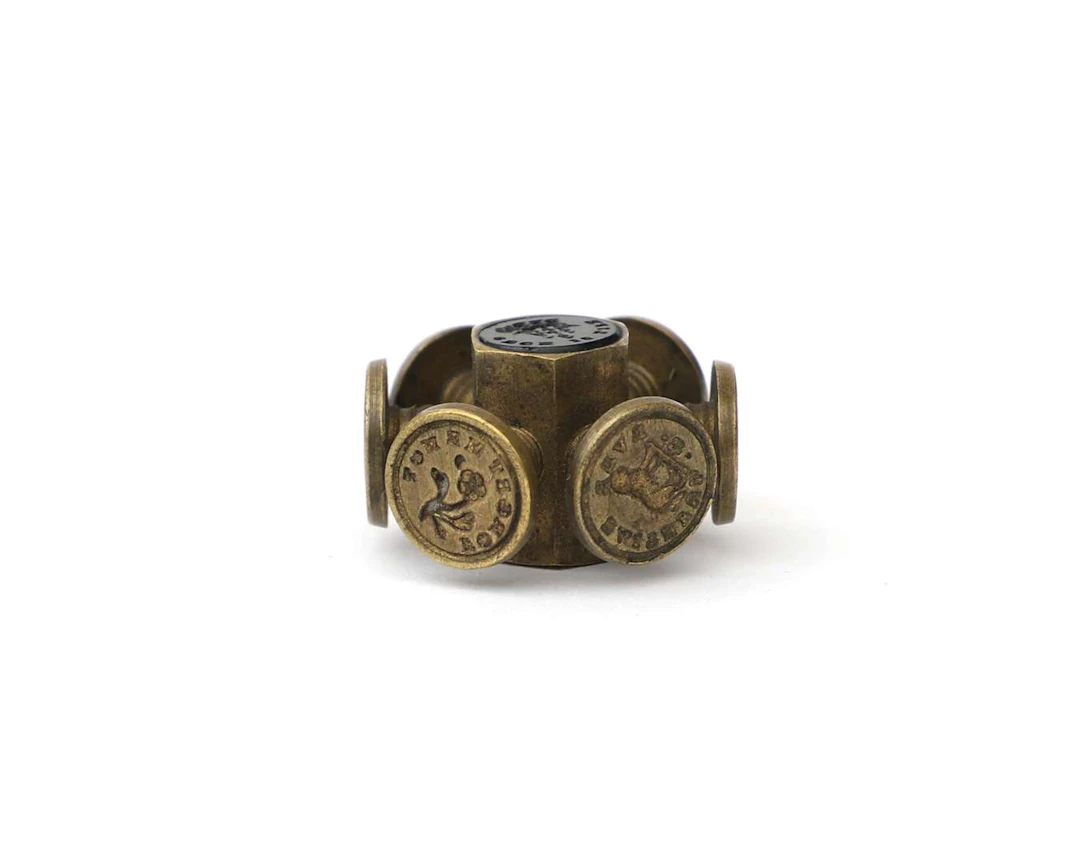A brass seal wheel with a love theme, England, 19th century
