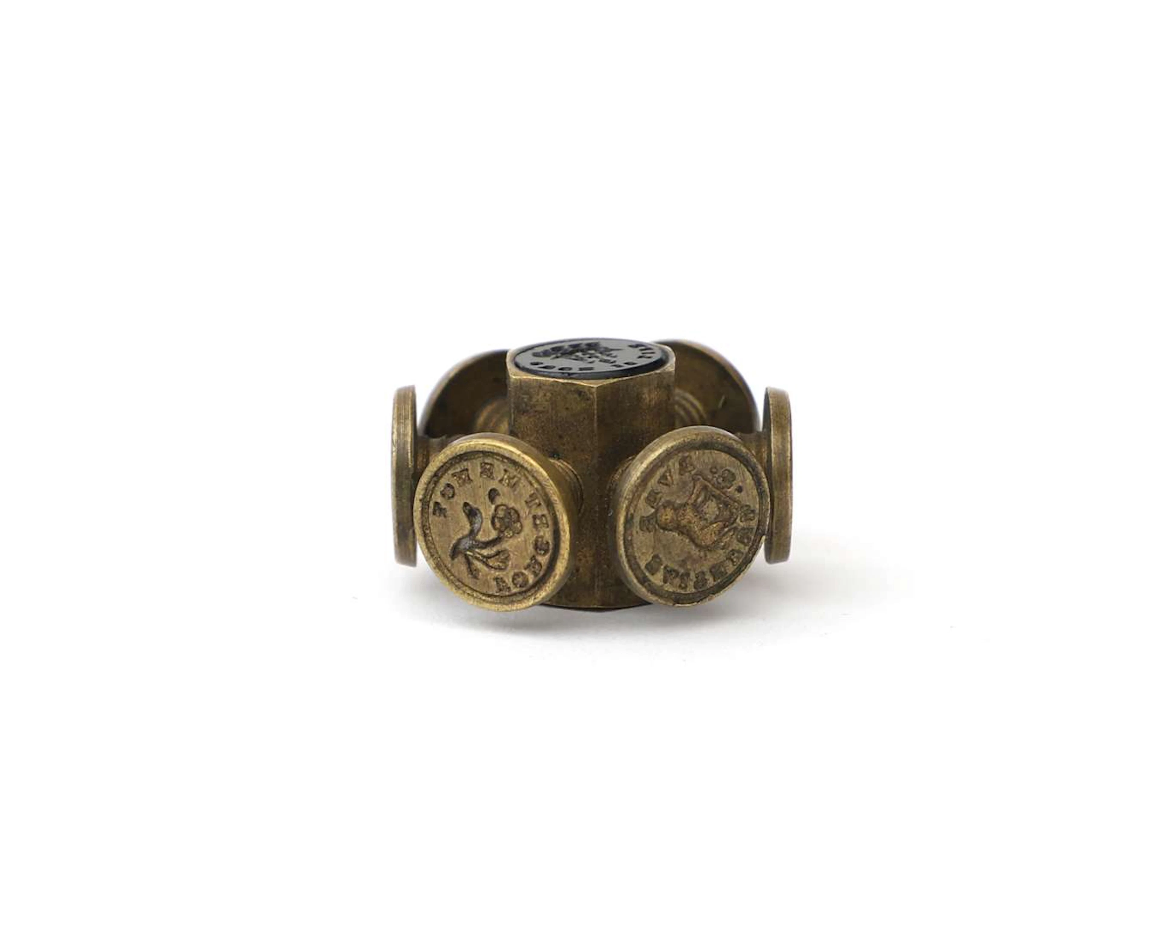 A brass seal wheel with a love theme, England, 19th century