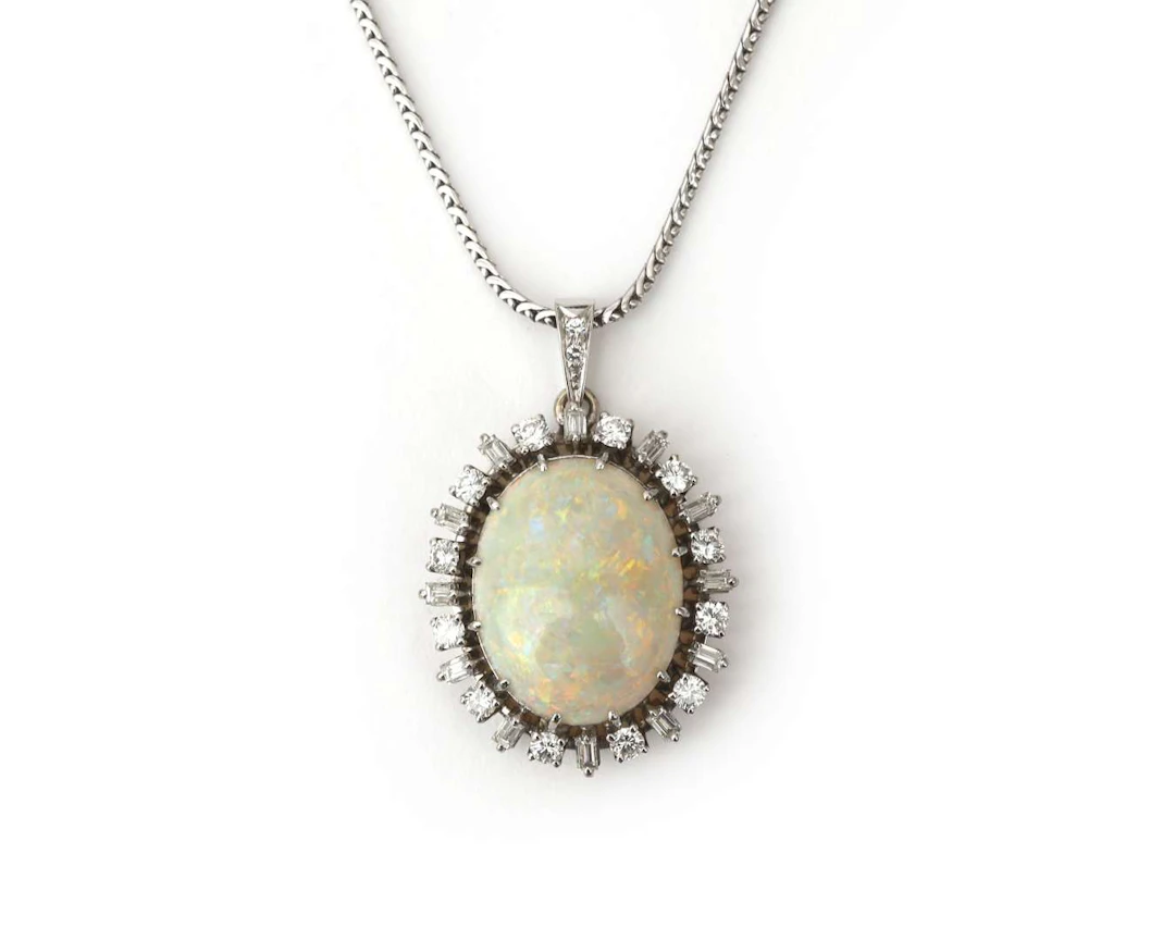 An 18k white gold necklace with a pendant set with diamonds and an opal