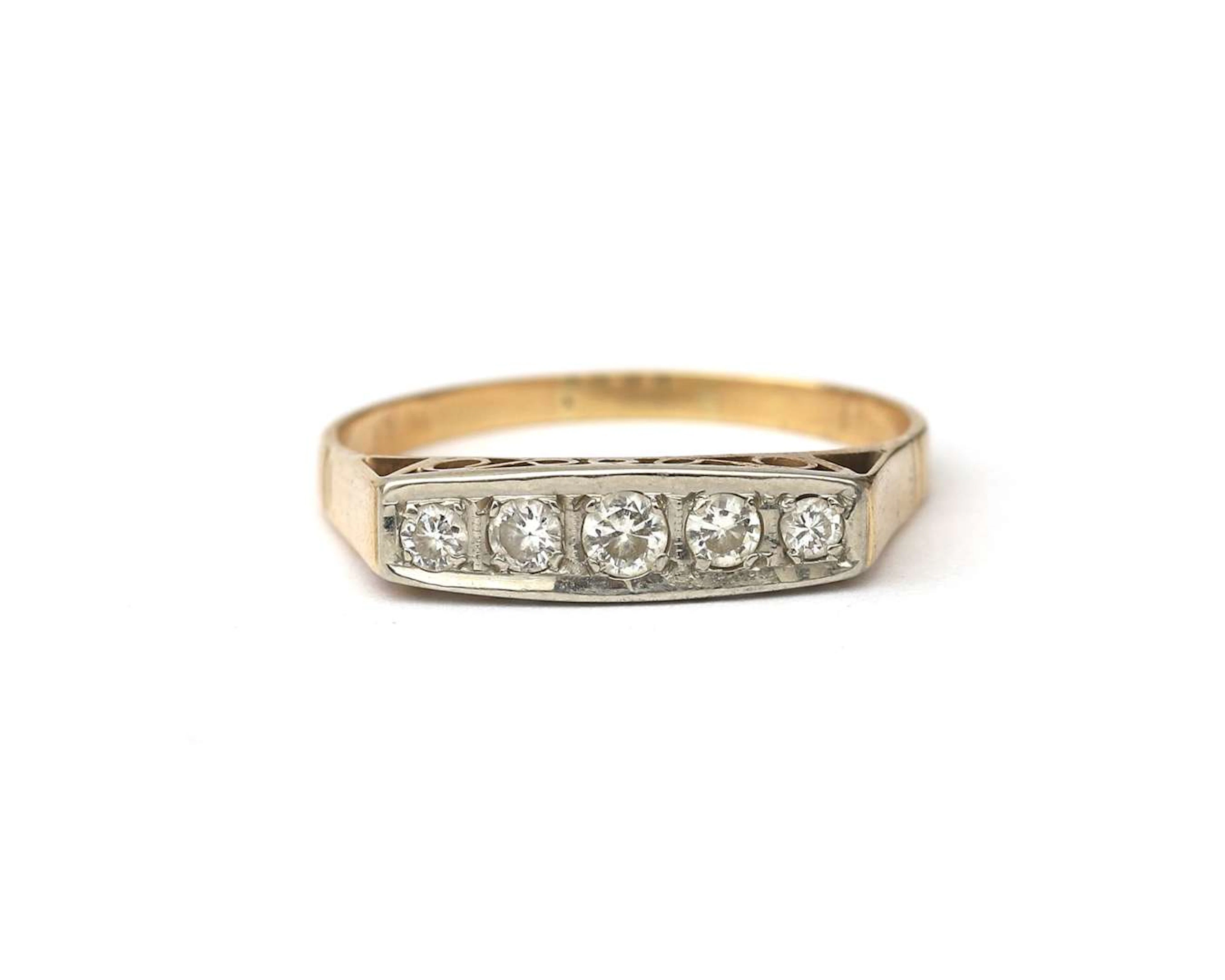 A 14k two-tone gold signet ring set with a diamond