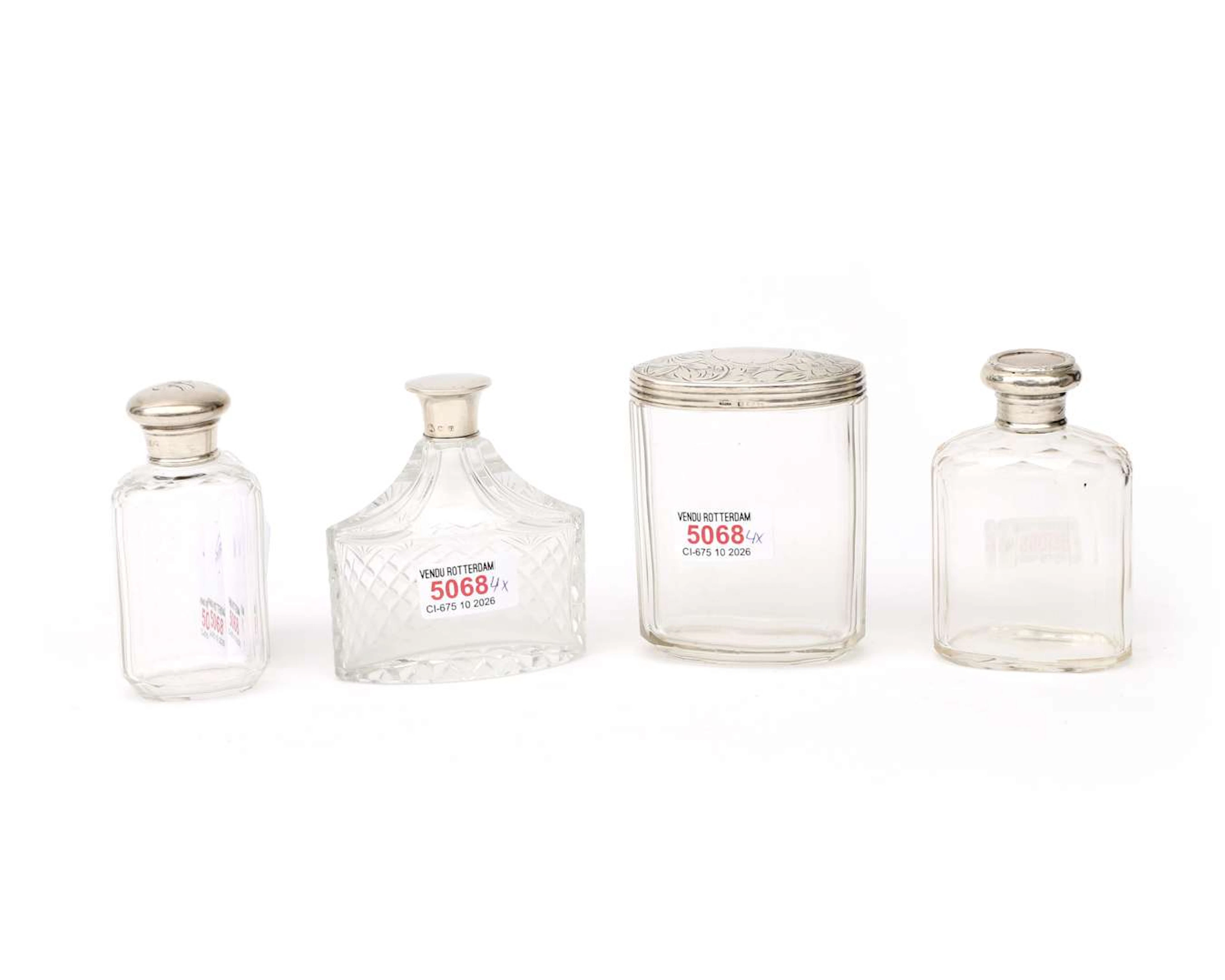 Set of four toiletries with sterling silver lids, England, 20th century