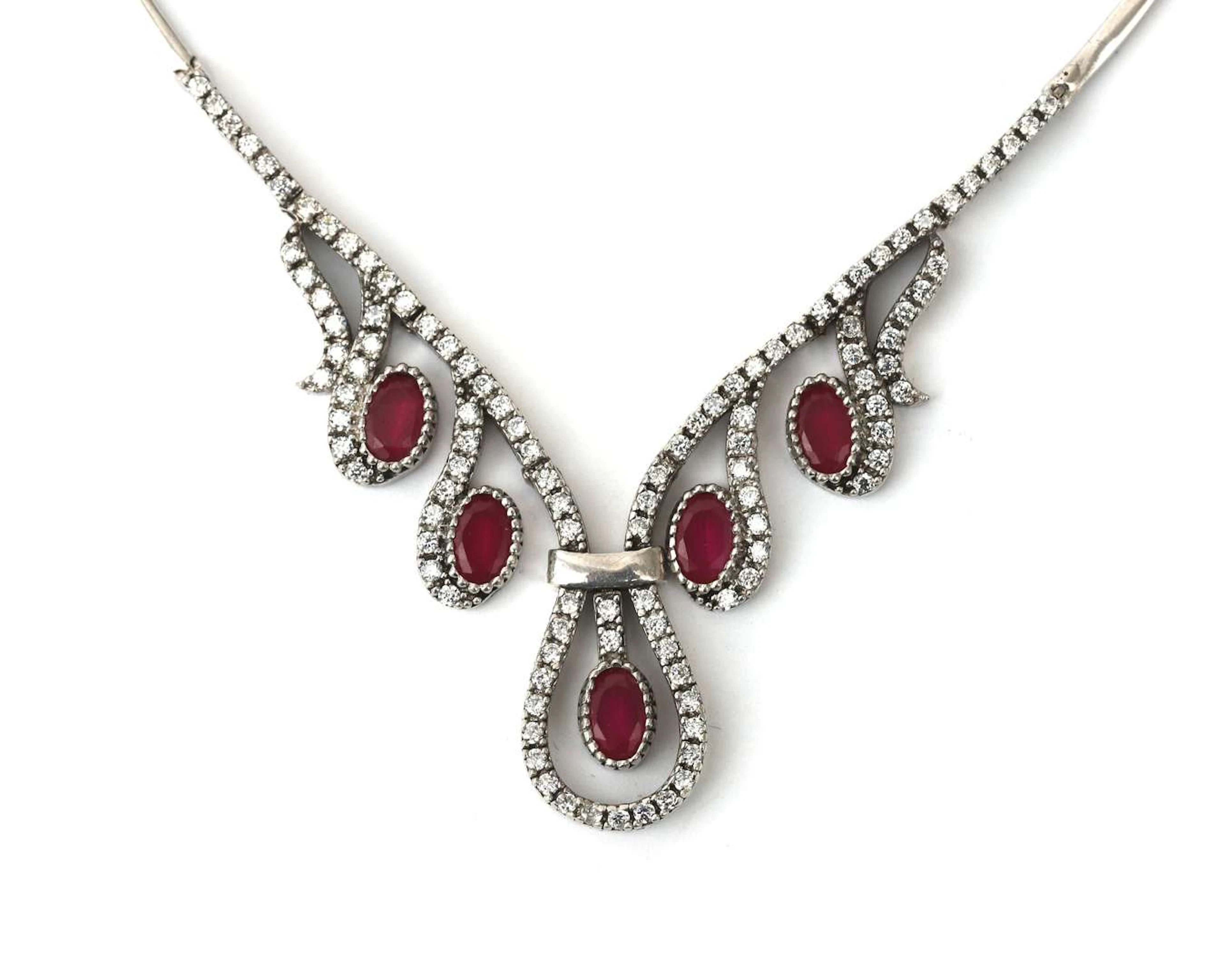 A sterling silver necklace with a synthetic ruby and cubic zirconia