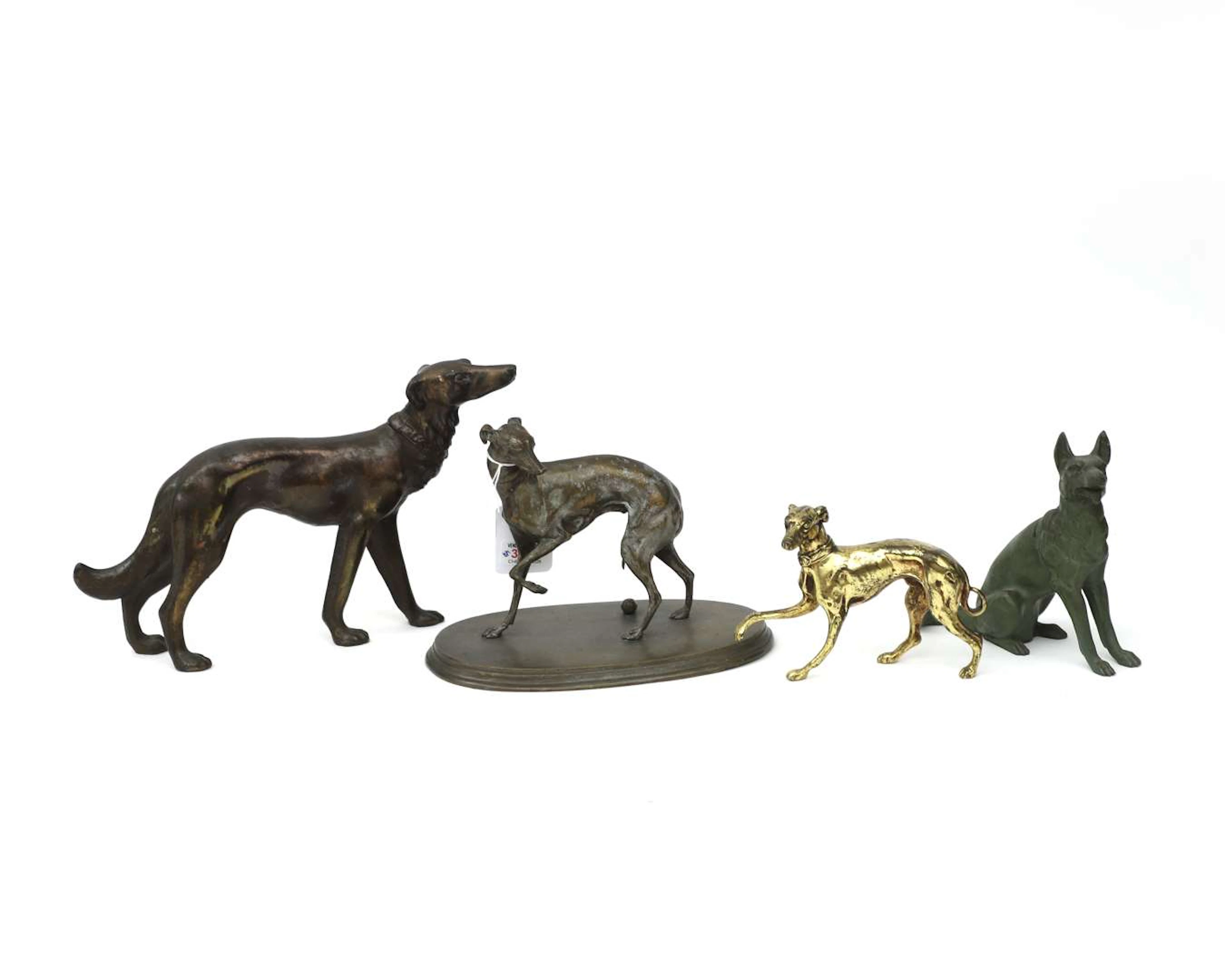 Four different metal/bronze sculptures. Dogs