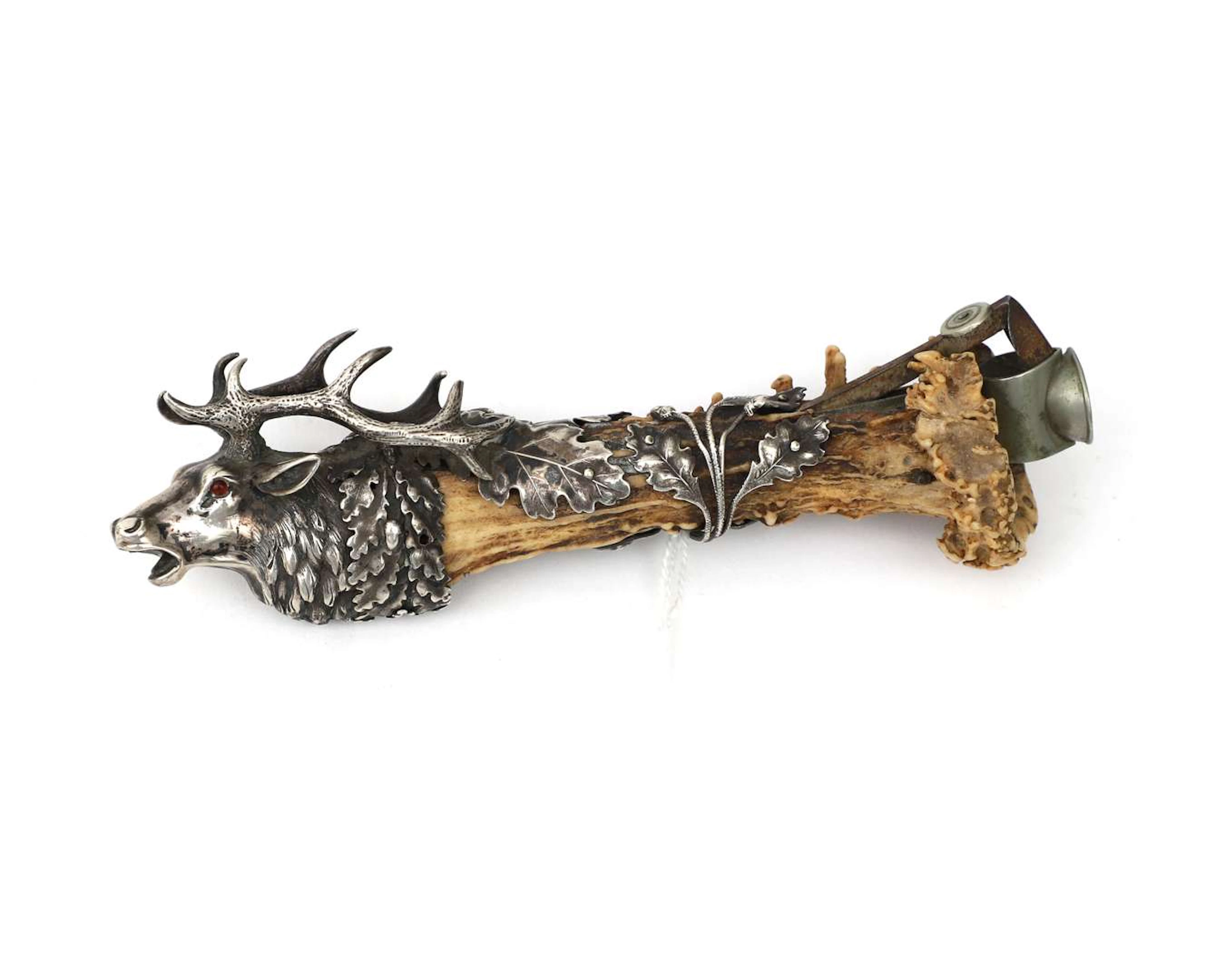 A sterling silver cigar cutter in the shape of a red deer with antlers