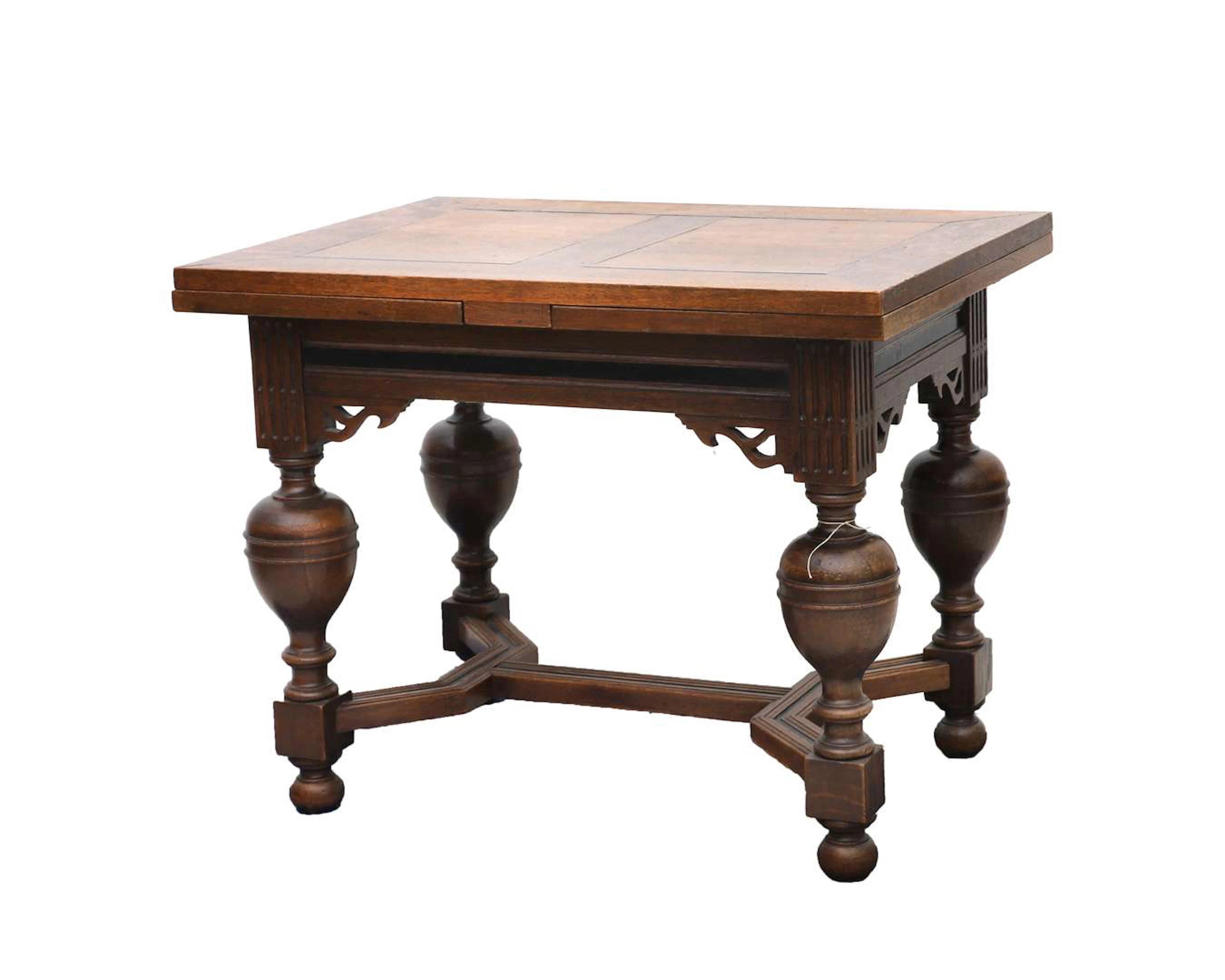 An oak table with a ball-and-socket joint and extendable leaves. 20th century