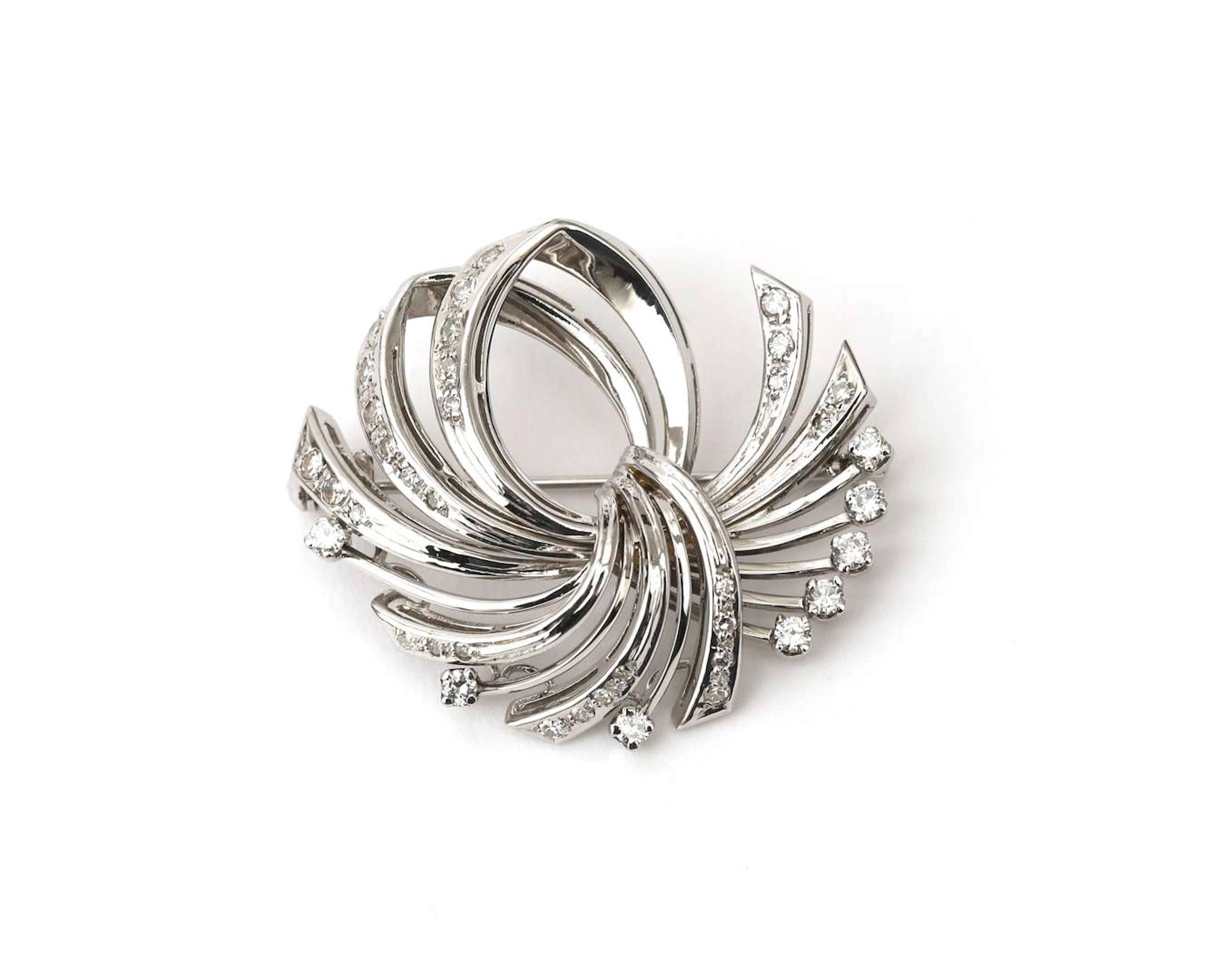 A 14k white gold brooch set with a diamond, c. 1950