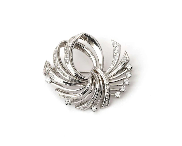 A 14k white gold brooch set with a diamond, c. 1950