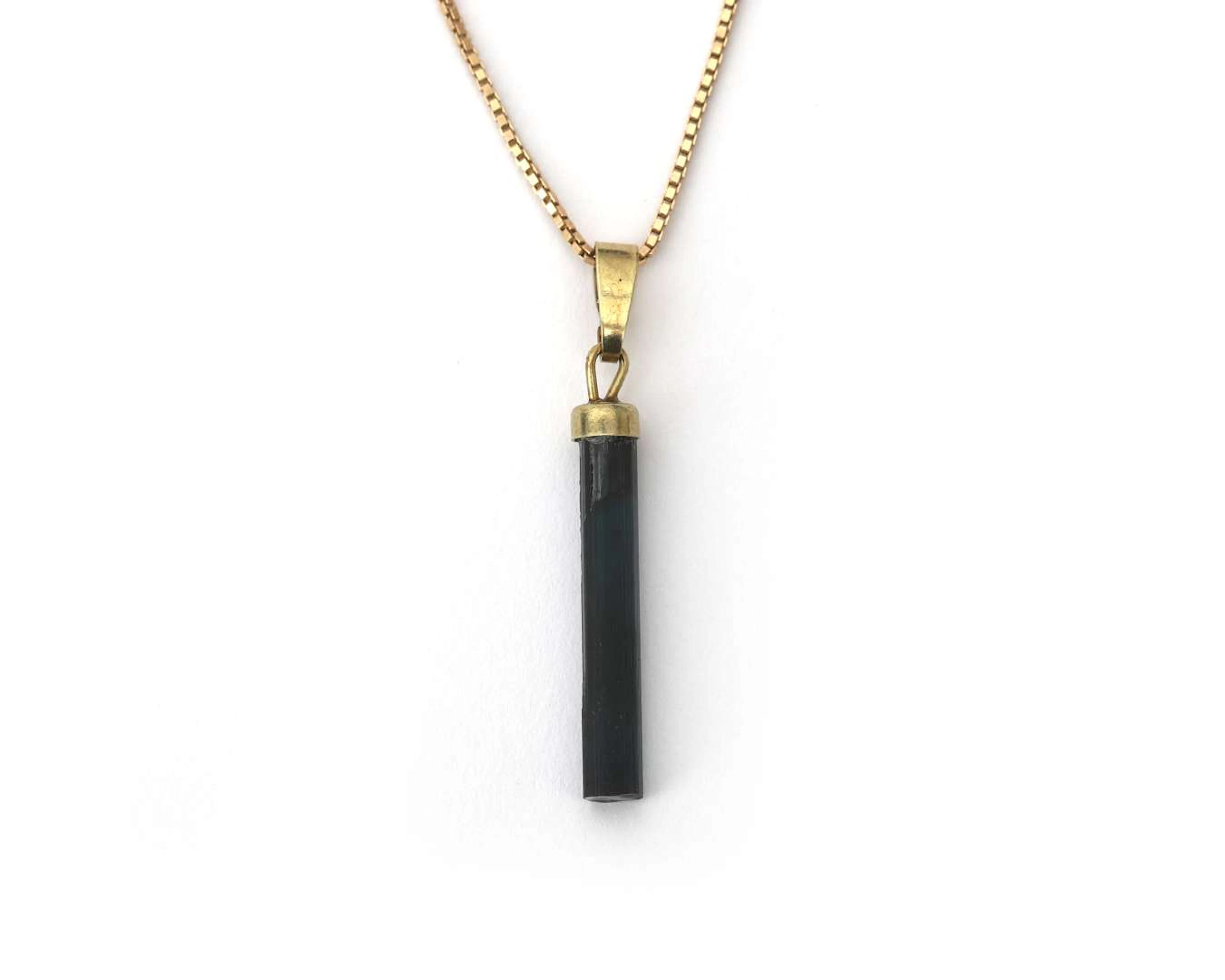 A pendant with tourmaline on 14k yellow gold necklace