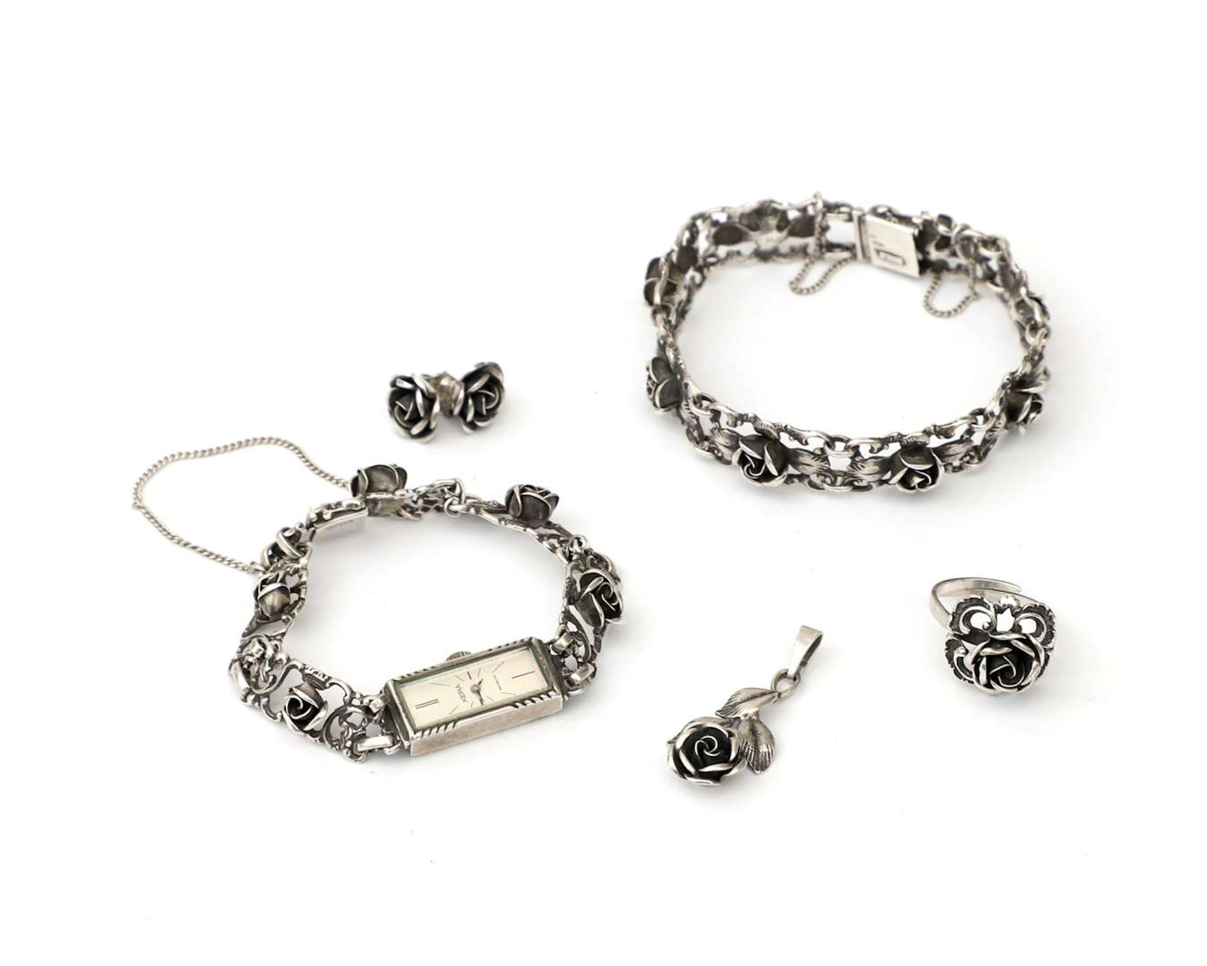 A variety of first- and second-grade silver jewellery featuring roses