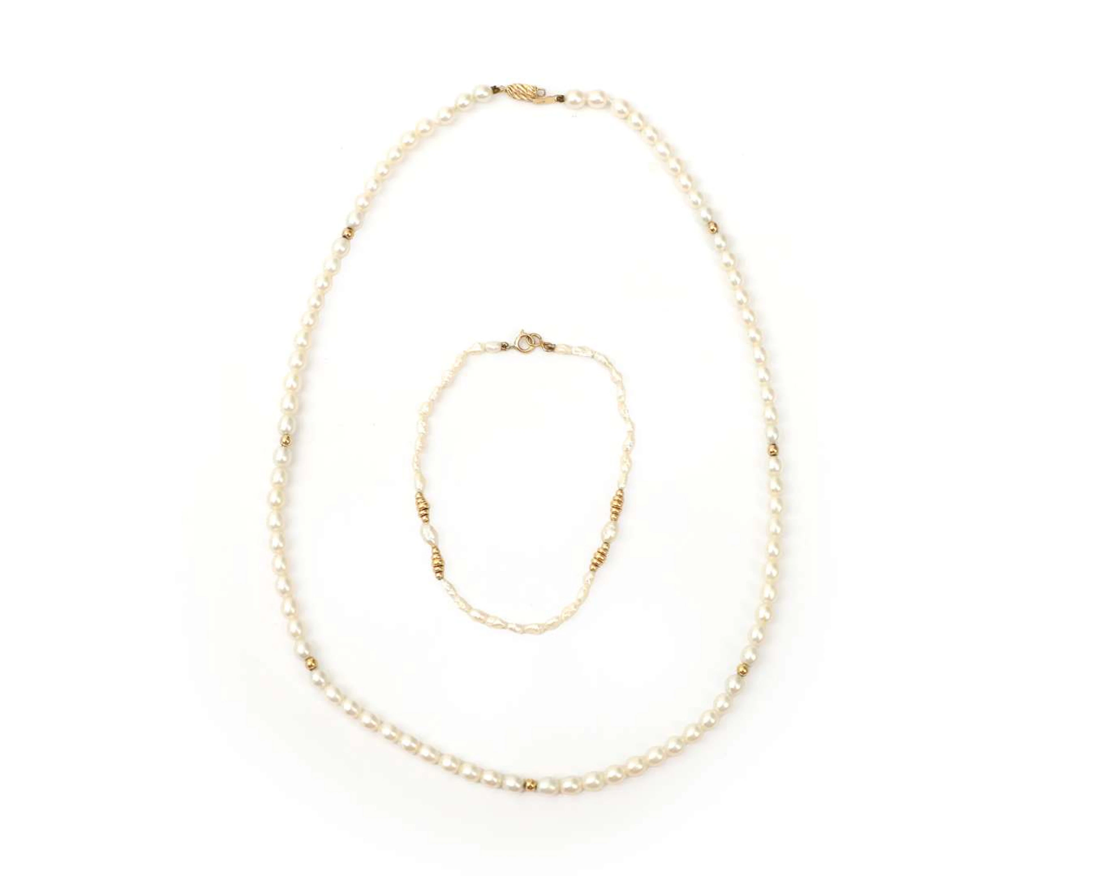 A set comprising a pearl necklace and bracelet with 14k yellow gold details