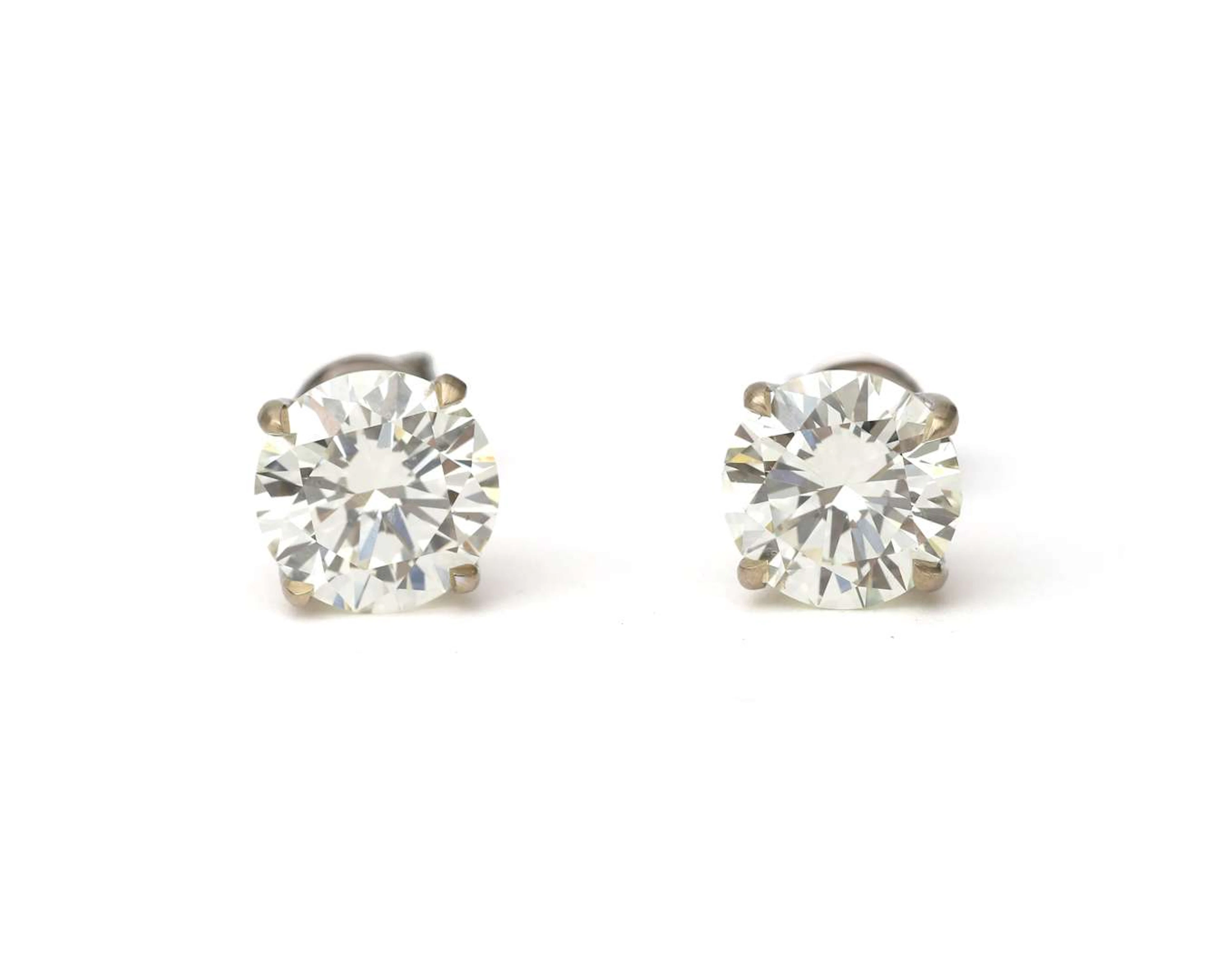 A pair of 18-carat white gold diamond stud earrings, totalling approx. 4.52 ct.