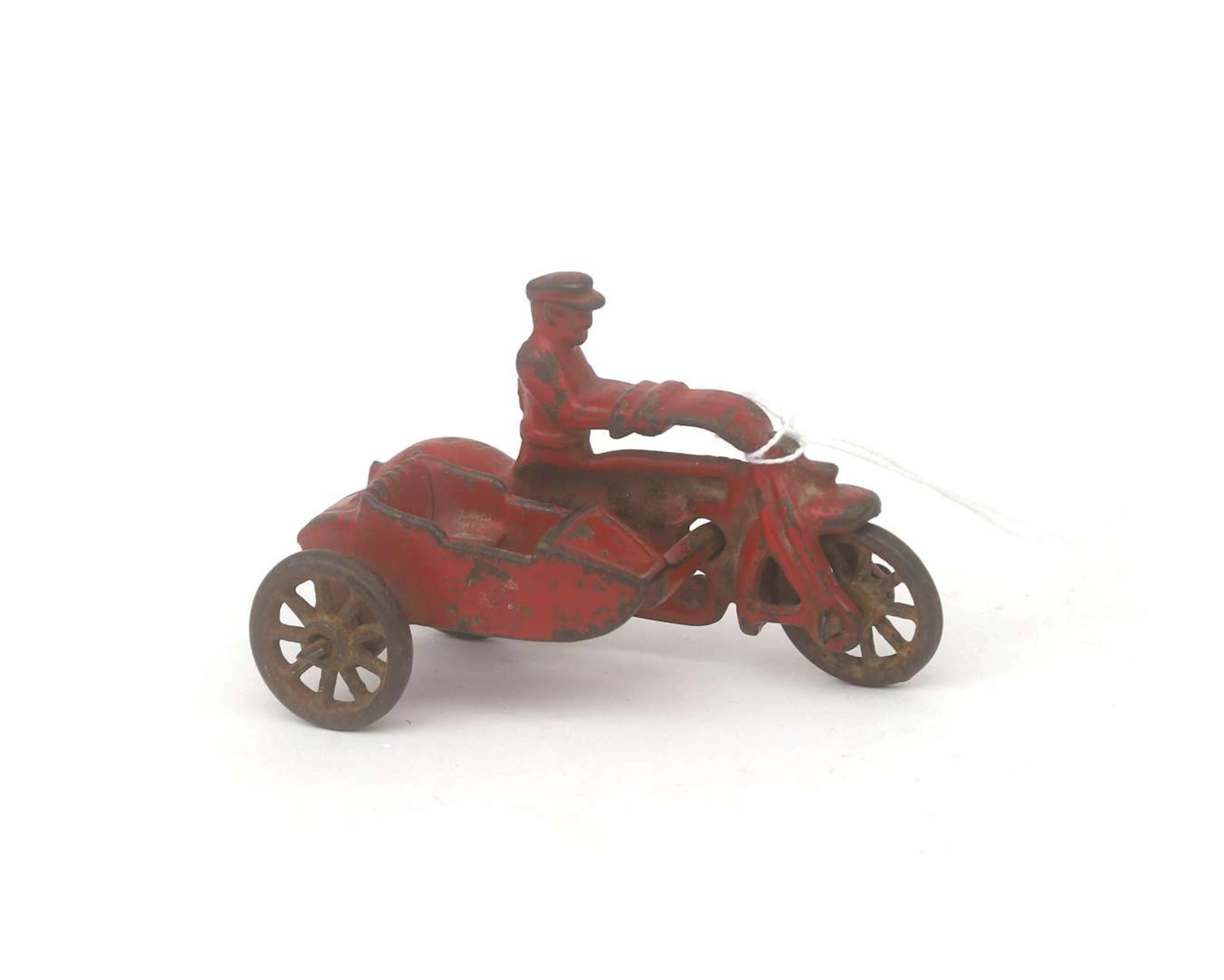 A cast iron toy motorbike with sidecar, probably Hubley, America, 20th century