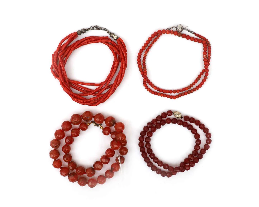 Four different necklaces, including one made of blood coral