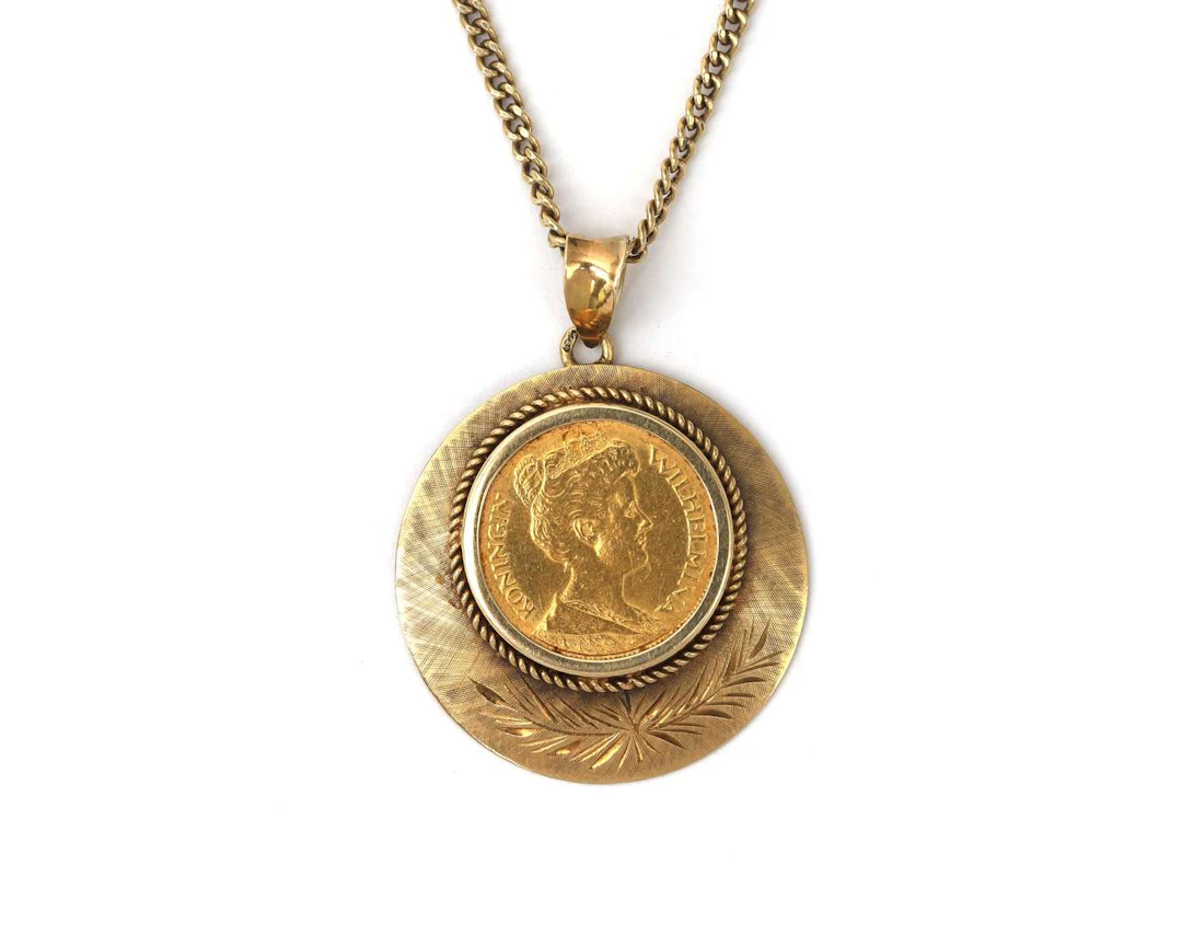 A 14k yellow gold necklace with an 18k pendant containing 5 guilders