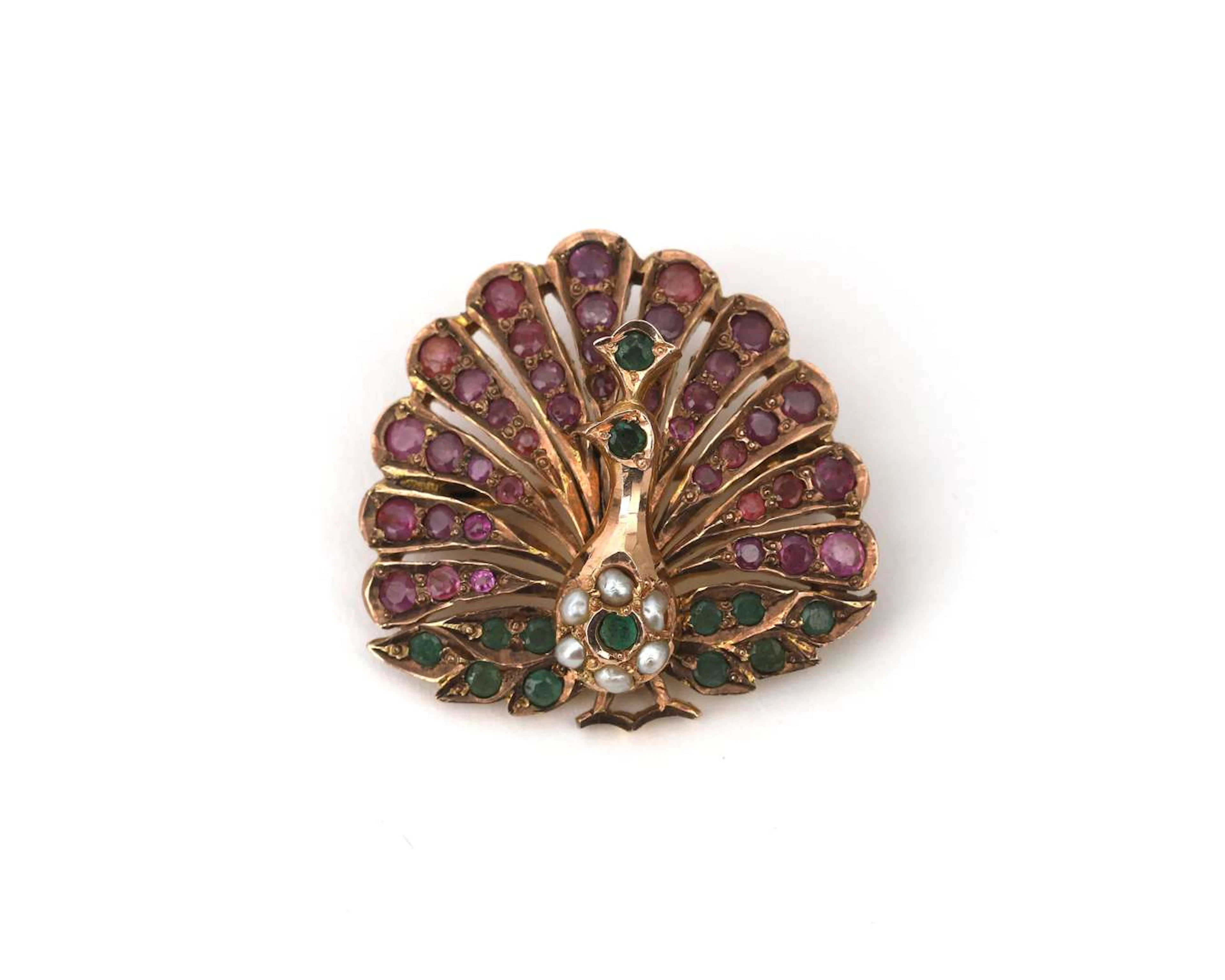 A BWG yellow gold brooch/pendant in the shape of a peacock, set with