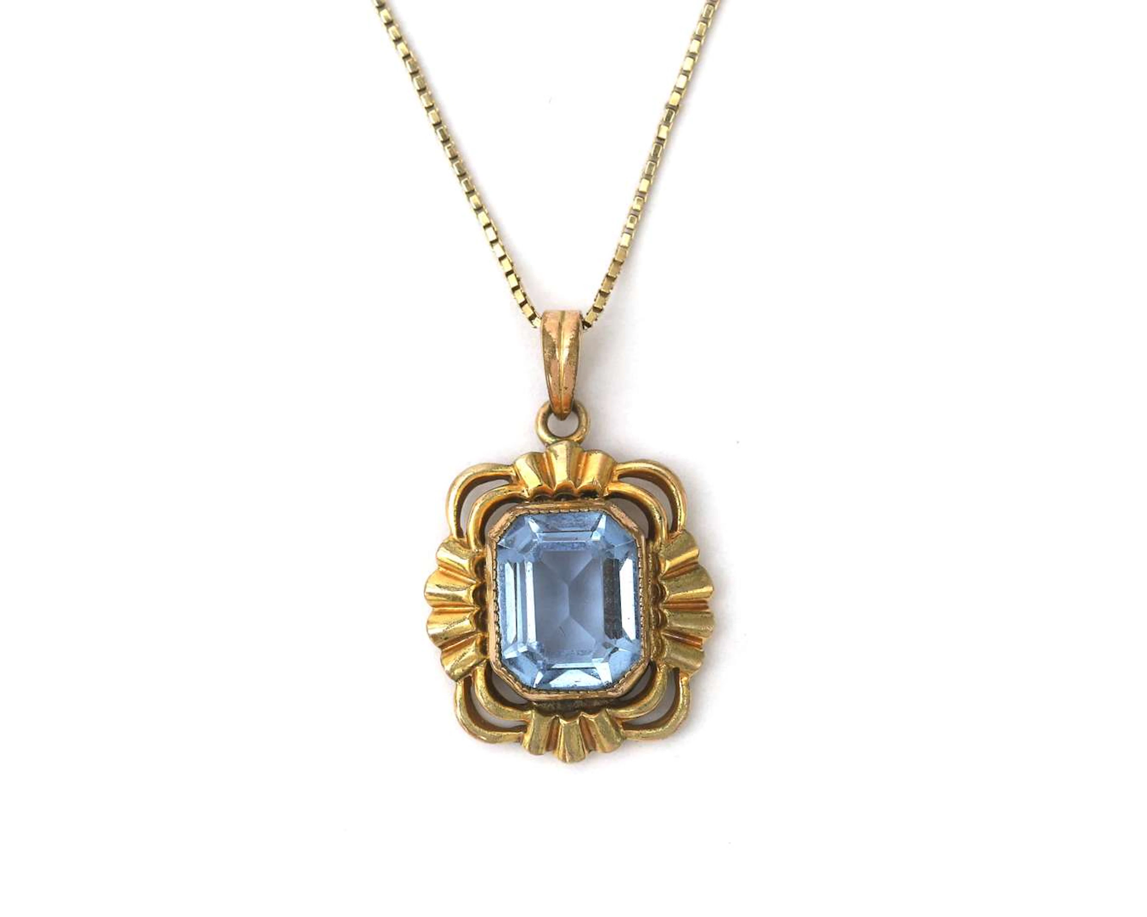 A 14k yellow gold necklace with a gold-plated pendant featuring a
