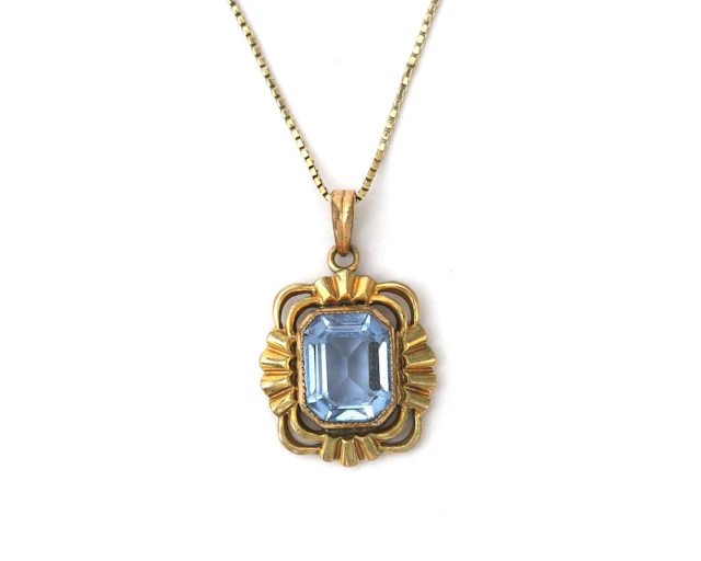 A 14k yellow gold necklace with a gold-plated pendant featuring a